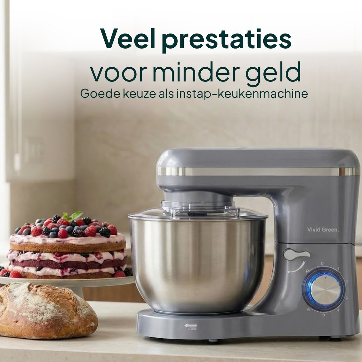 Gray stand mixer with bowl, next to bread and a cake.