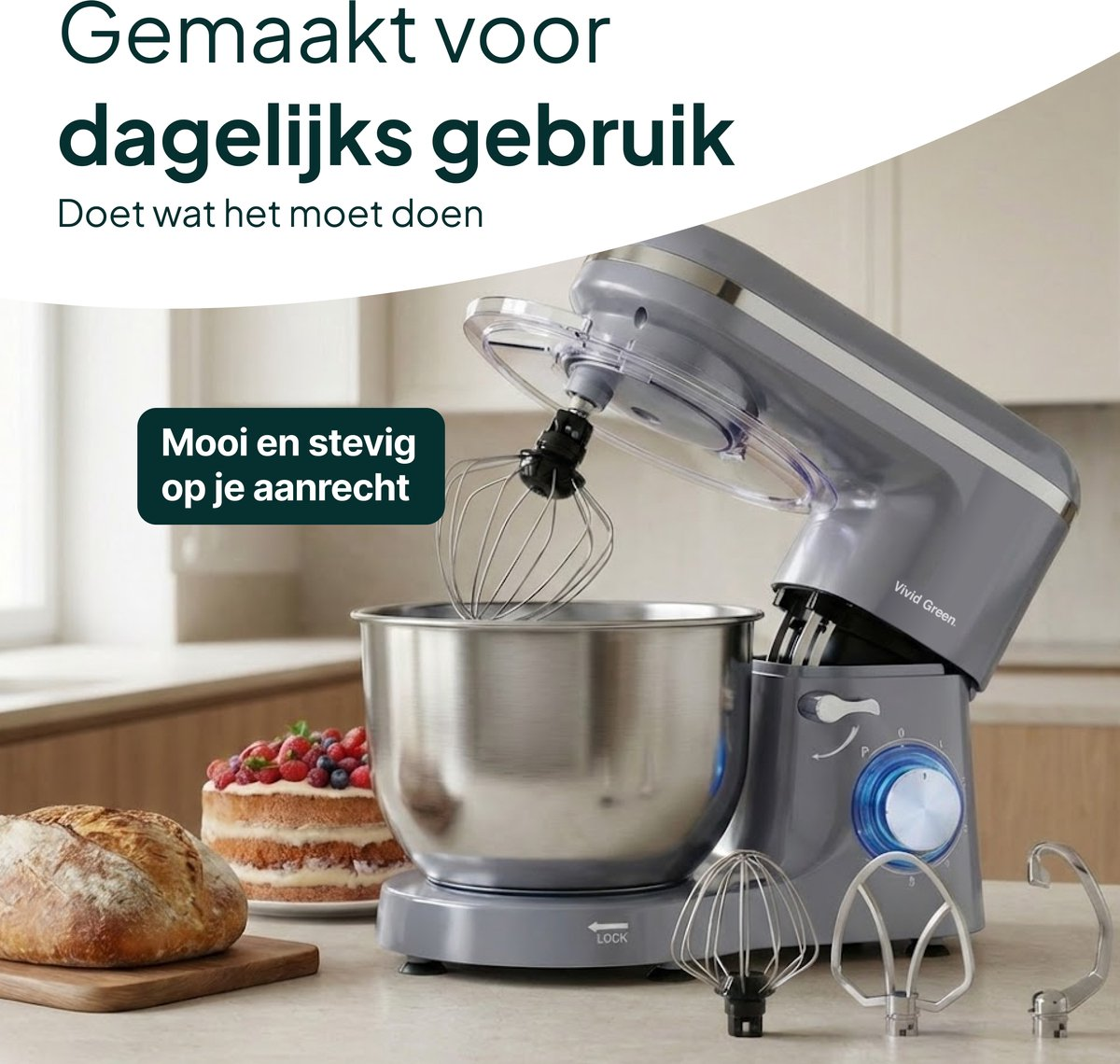 Grey kitchen mixer with whisk, bowl, bread, and cake.