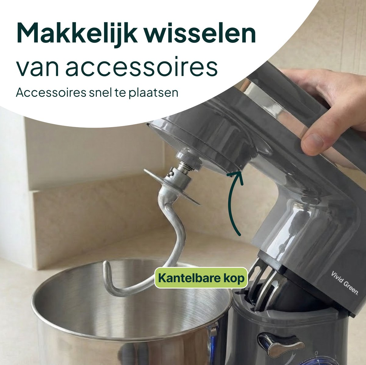 Gray stand mixer with dough hook in stainless steel bowl. Hand holds top part.