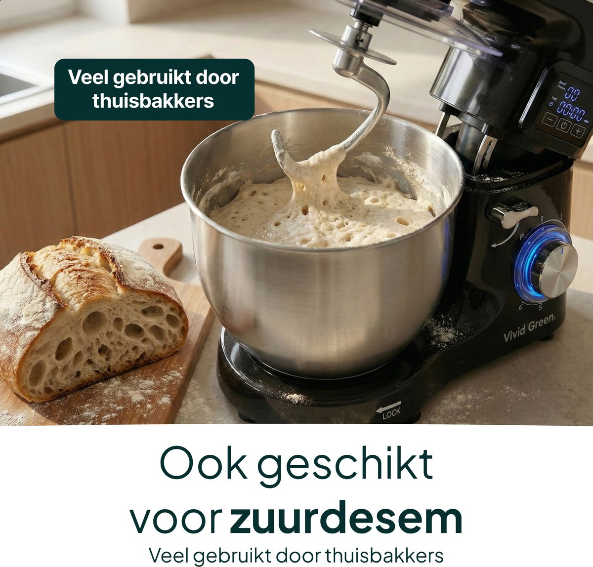 A black kitchen mixer kneads dough. A loaf of bread sits beside it.