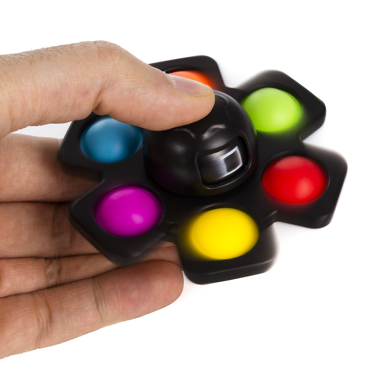 Un dedo presiona un spinner negro con bolas de colores: naranja, verde, rojo, amarillo, rosa, azul.