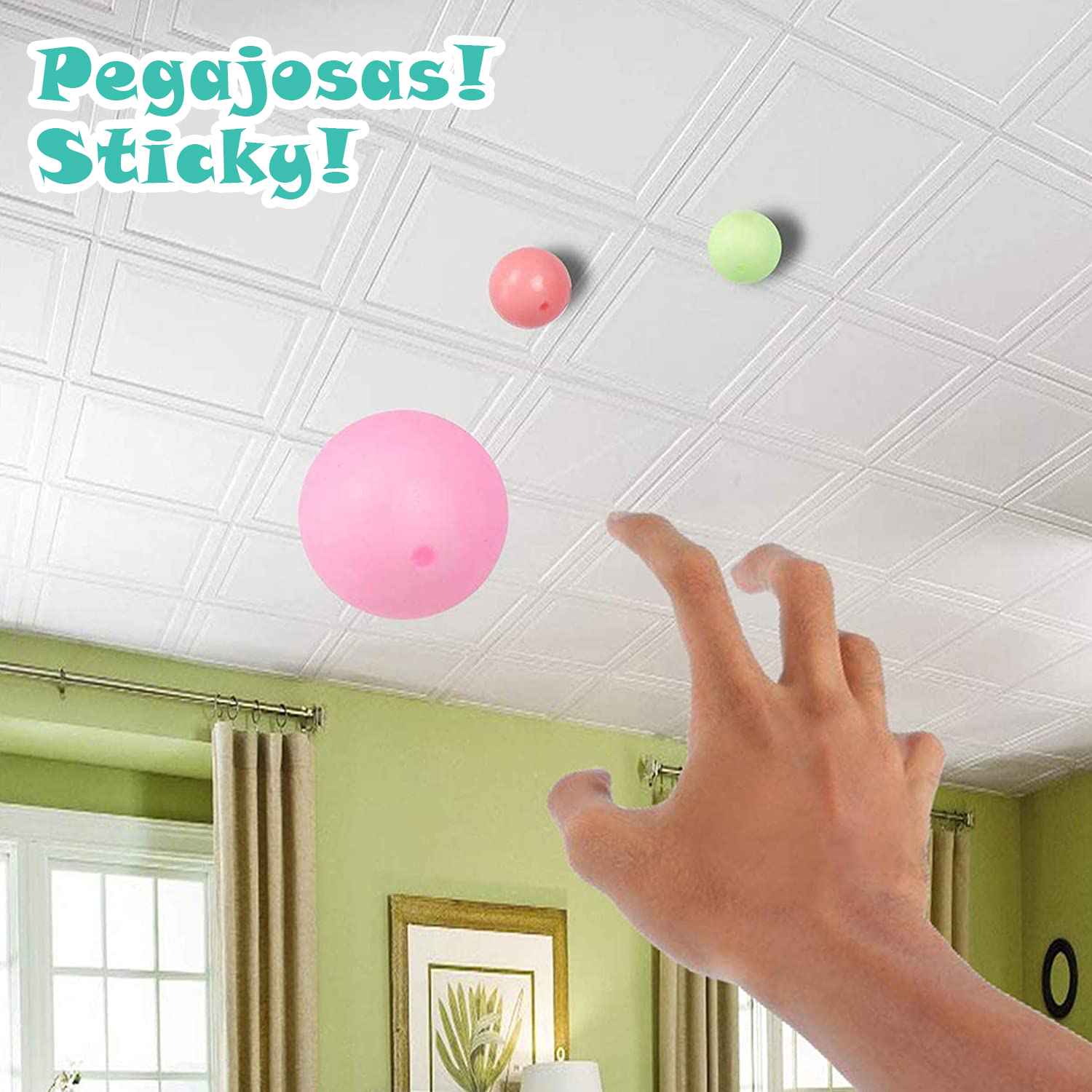 Mano cogiendo pelotas de colores en techo blanco con texto.