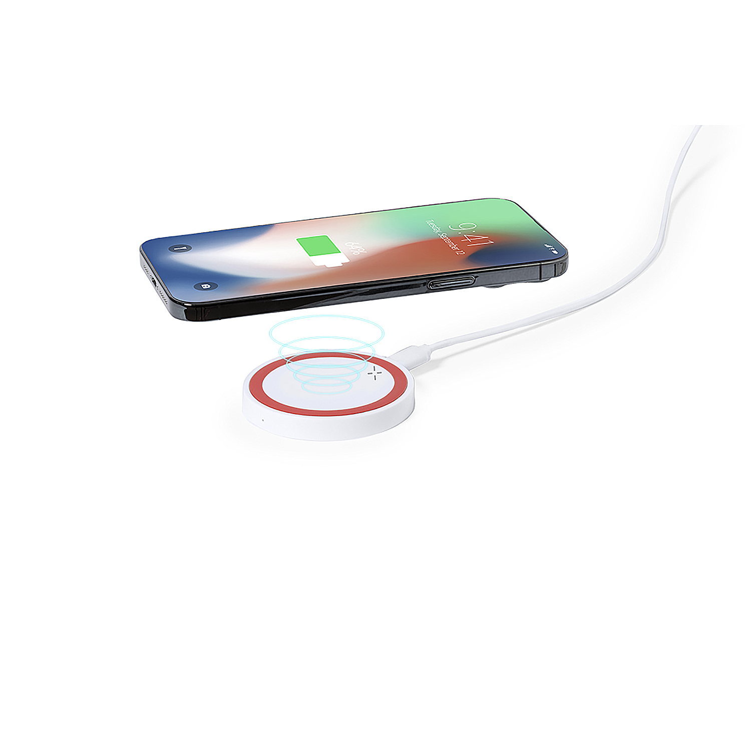 Uno smartphone si ricarica in modalità wireless su un pad di ricarica rotondo.
