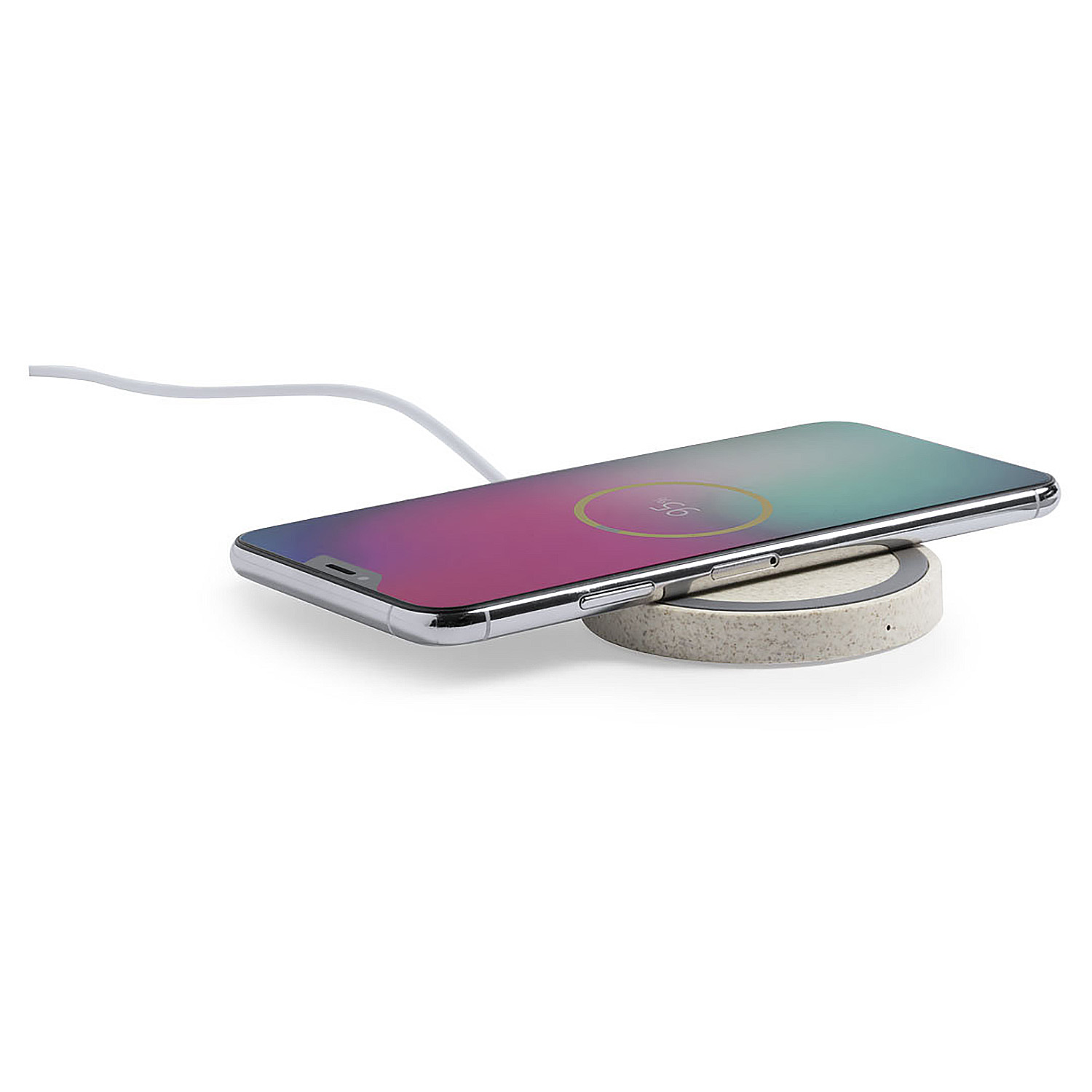 Un smartphone se está cargando en una estación de carga redonda y beige.