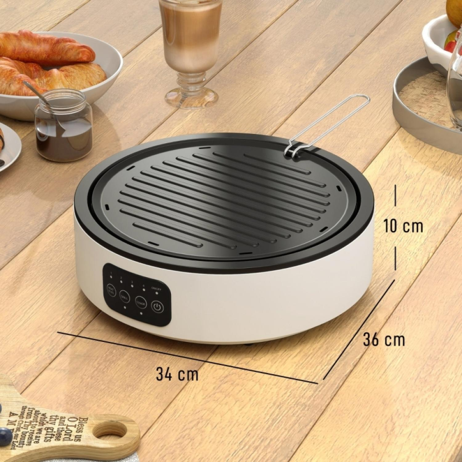 Ein runder weißer Grill mit schwarzer gerippter Oberfläche steht auf einem Holztisch.