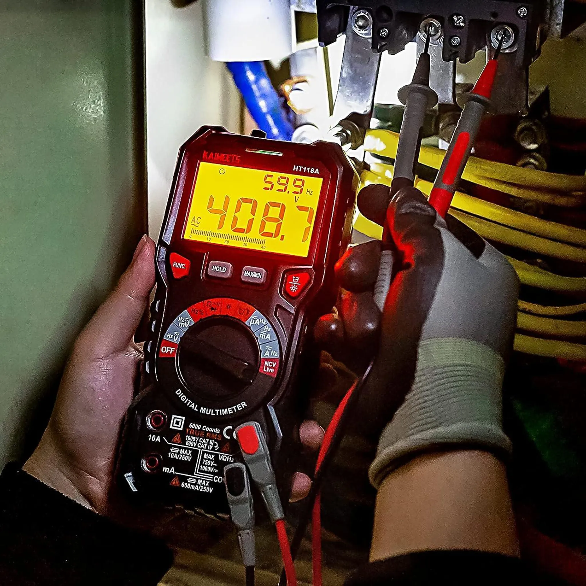 Ein Multimeter misst 408,7V AC in einem elektrischen System. Hände mit Handschuhen halten es.