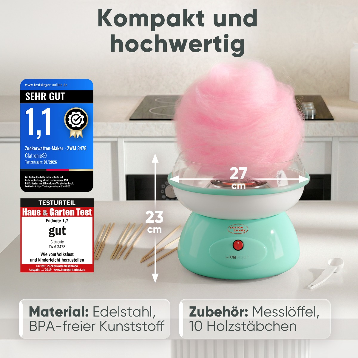 Ein türkiser Zuckerwattemaker mit viel rosa Zuckerwatte, 27cm breit, 23cm hoch.