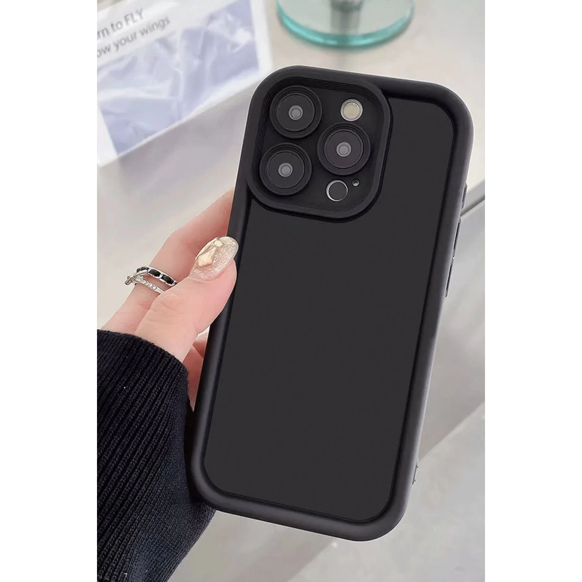 Dört kamera lensli siyah akıllı telefon kılıfı.