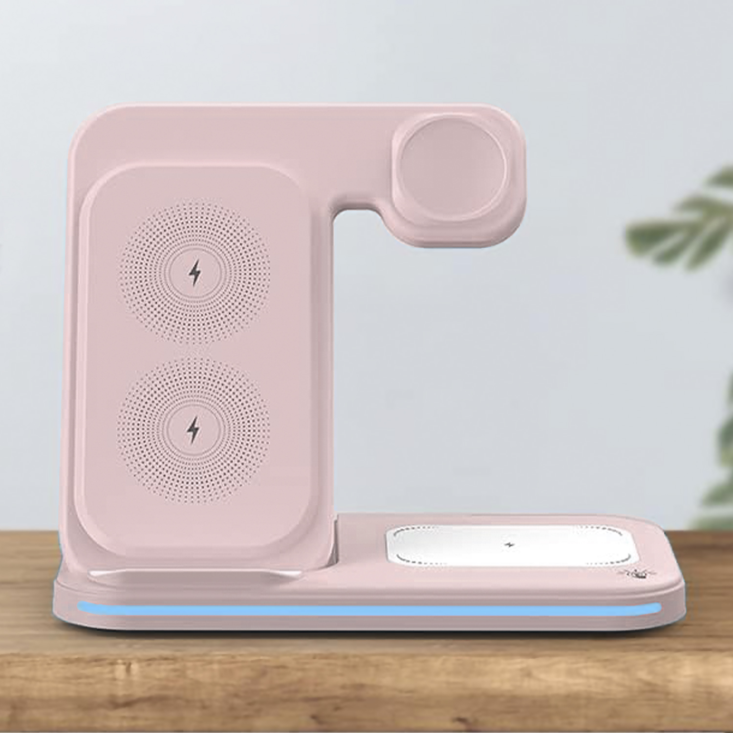 Un soporte de carga inalámbrica rosa con dos almohadillas y un cargador de reloj.
