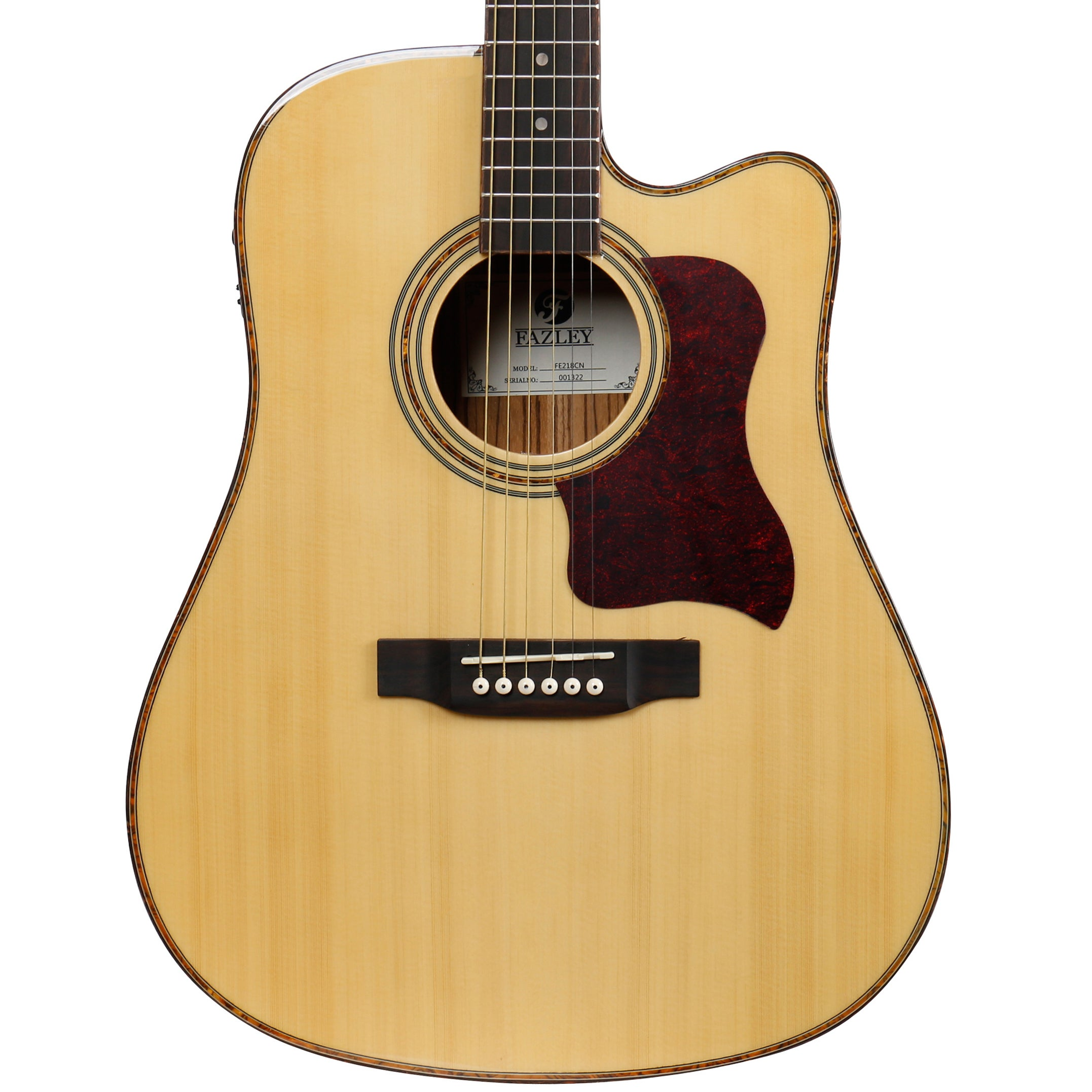 A close-up of a light-colored acoustic guitar with a tortoiseshell pickguard.