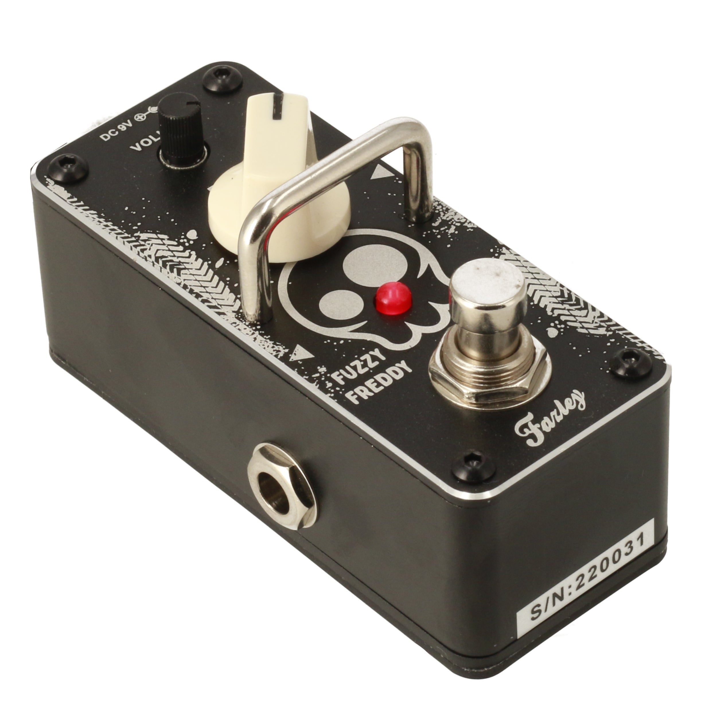 A black Fuzzy Freddy guitar effects pedal with a skull design and red LED light.