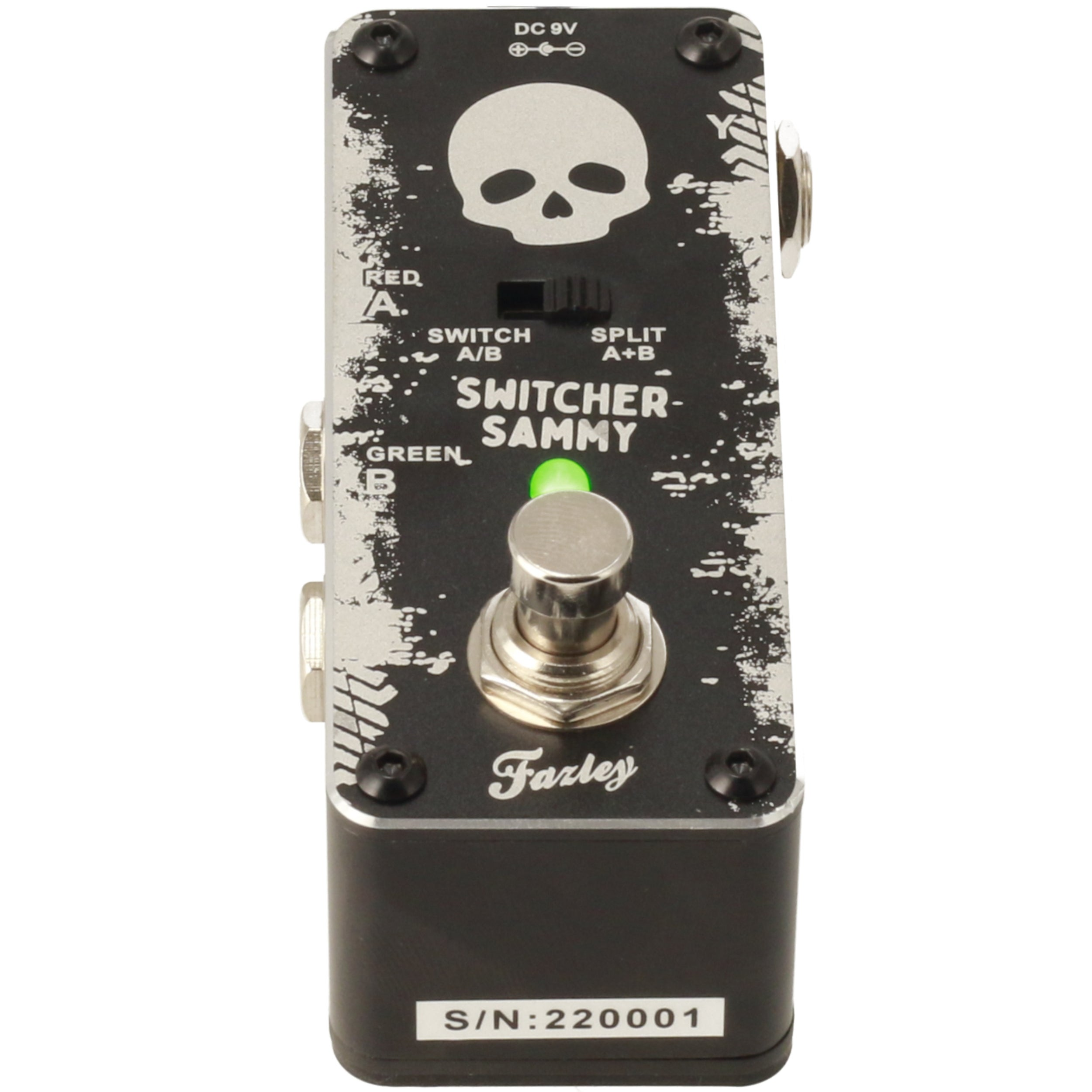A black guitar pedal with a skull graphic and a green LED light.