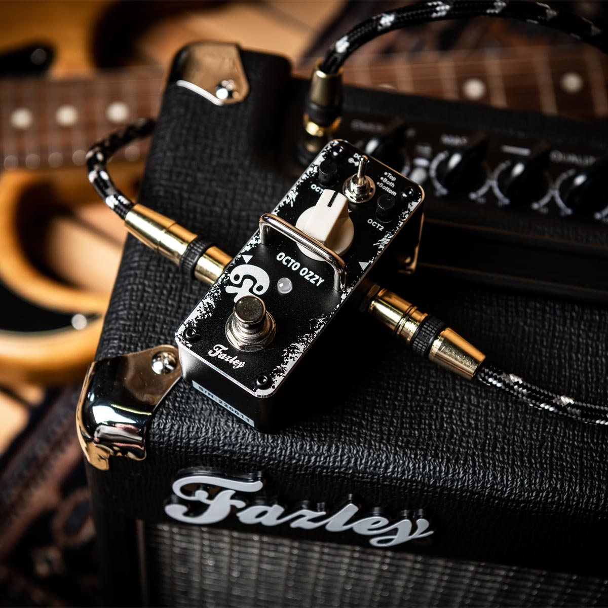 A black "Octo Ozzy" guitar effects pedal sits on top of a guitar amplifier.