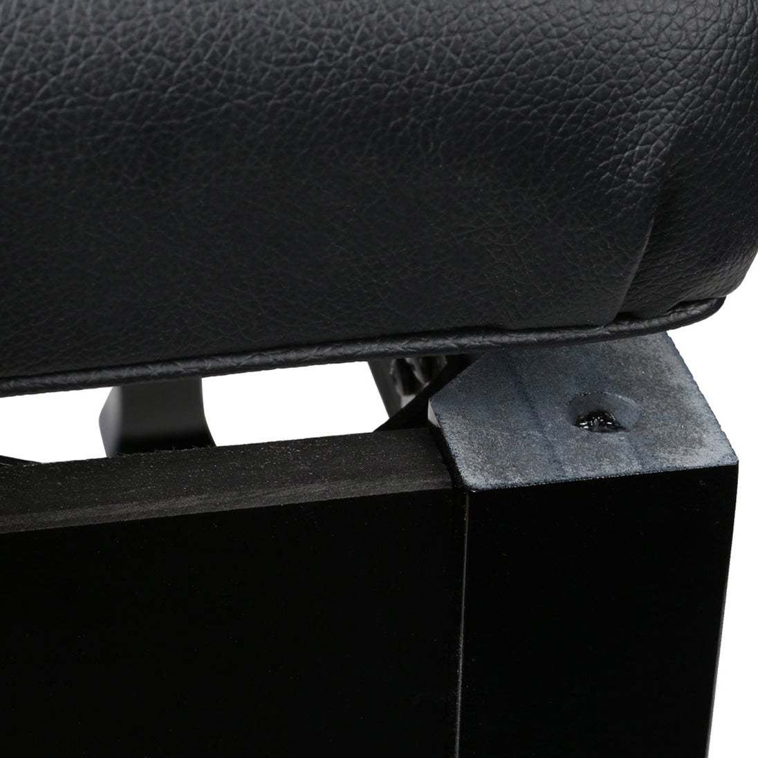 Close-up of black leather padding attached to a black metal frame.