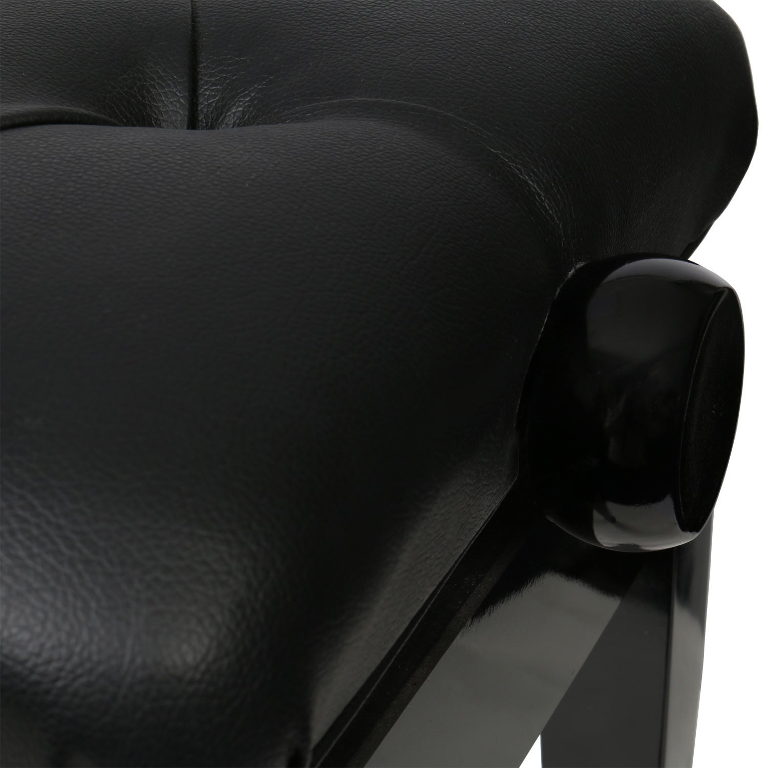 Close-up of a black leather stool with glossy details.