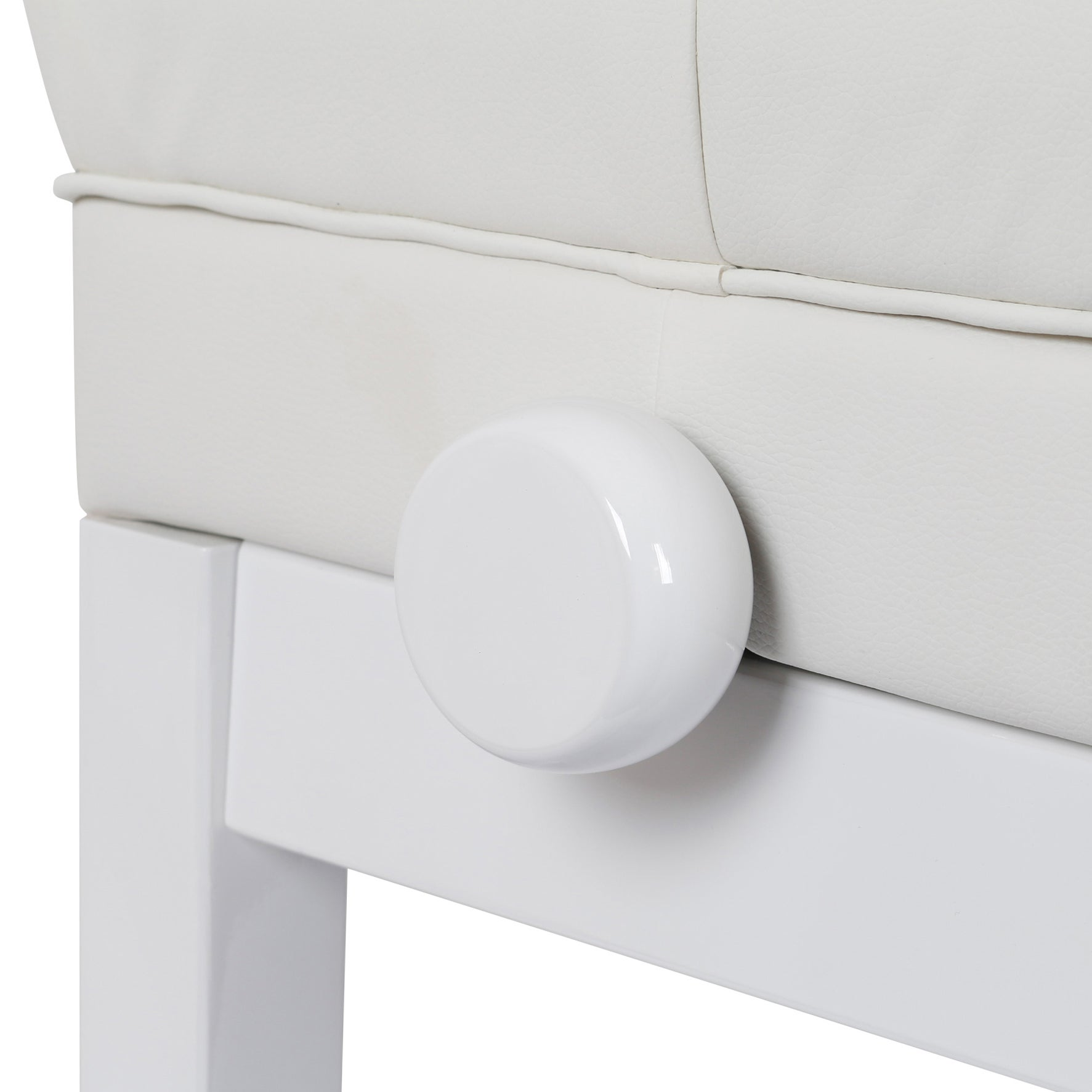 Close-up of a white round knob on a white stool.