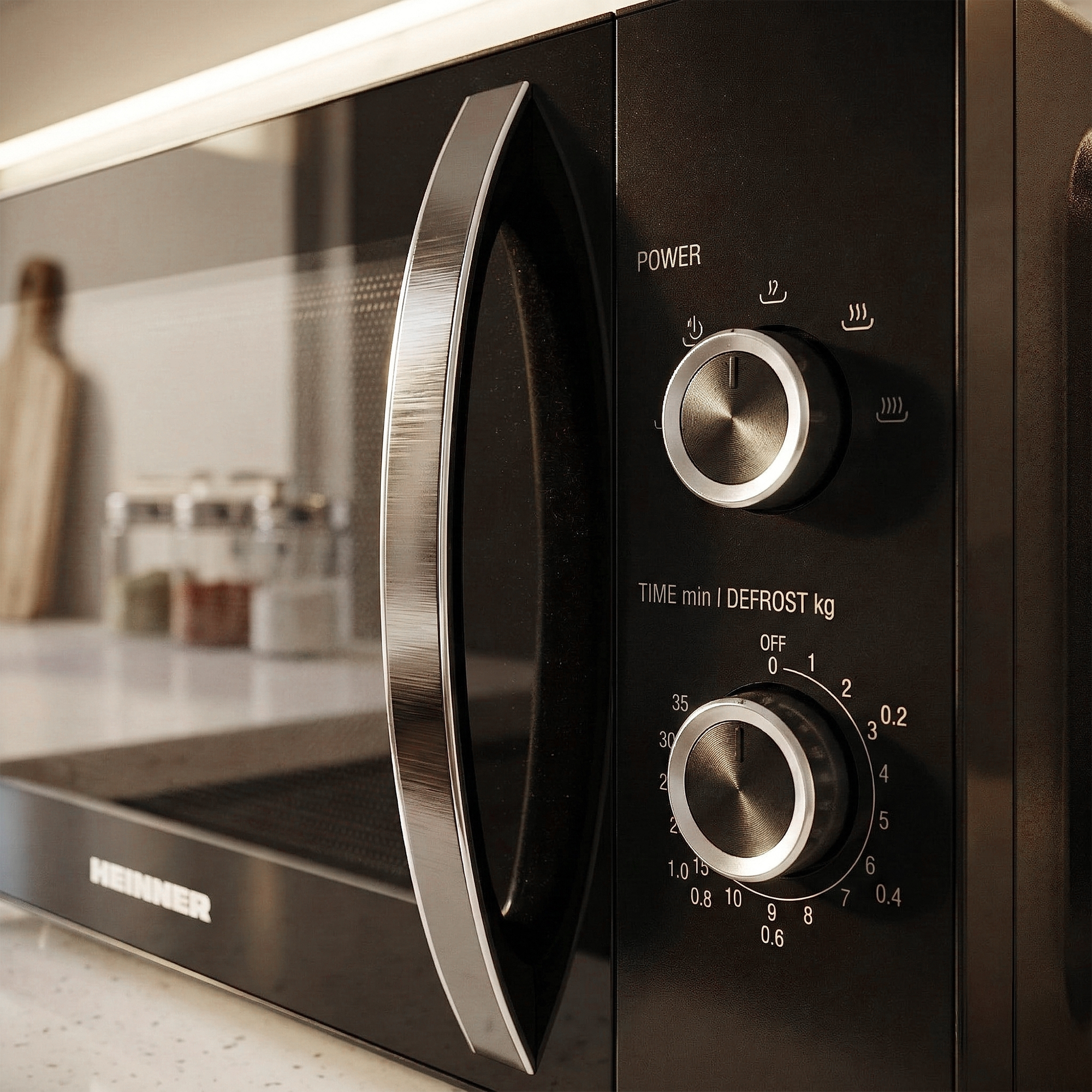 A black microwave oven with a silver handle and control knobs.