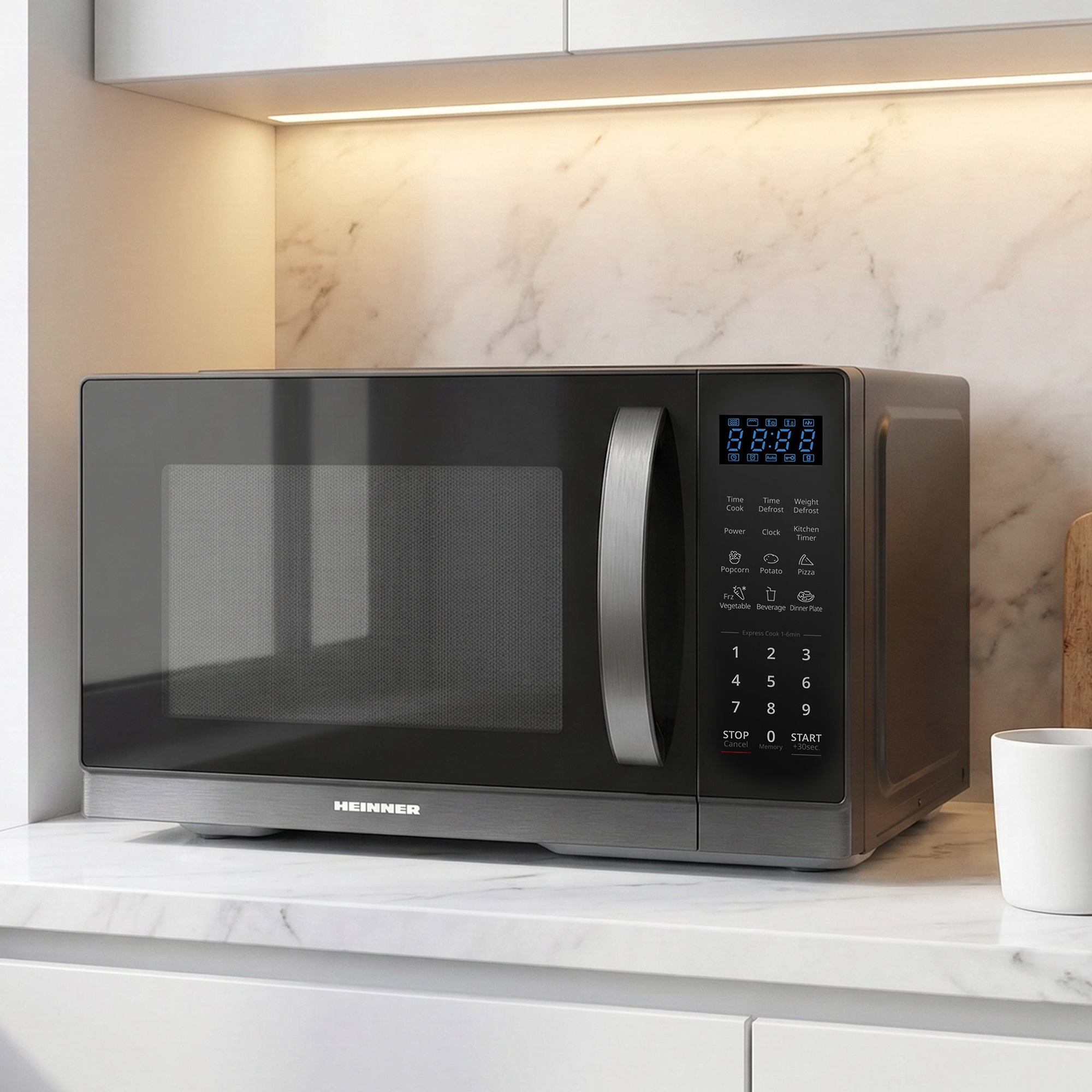 A modern, dark microwave with a silver handle on a marble countertop.