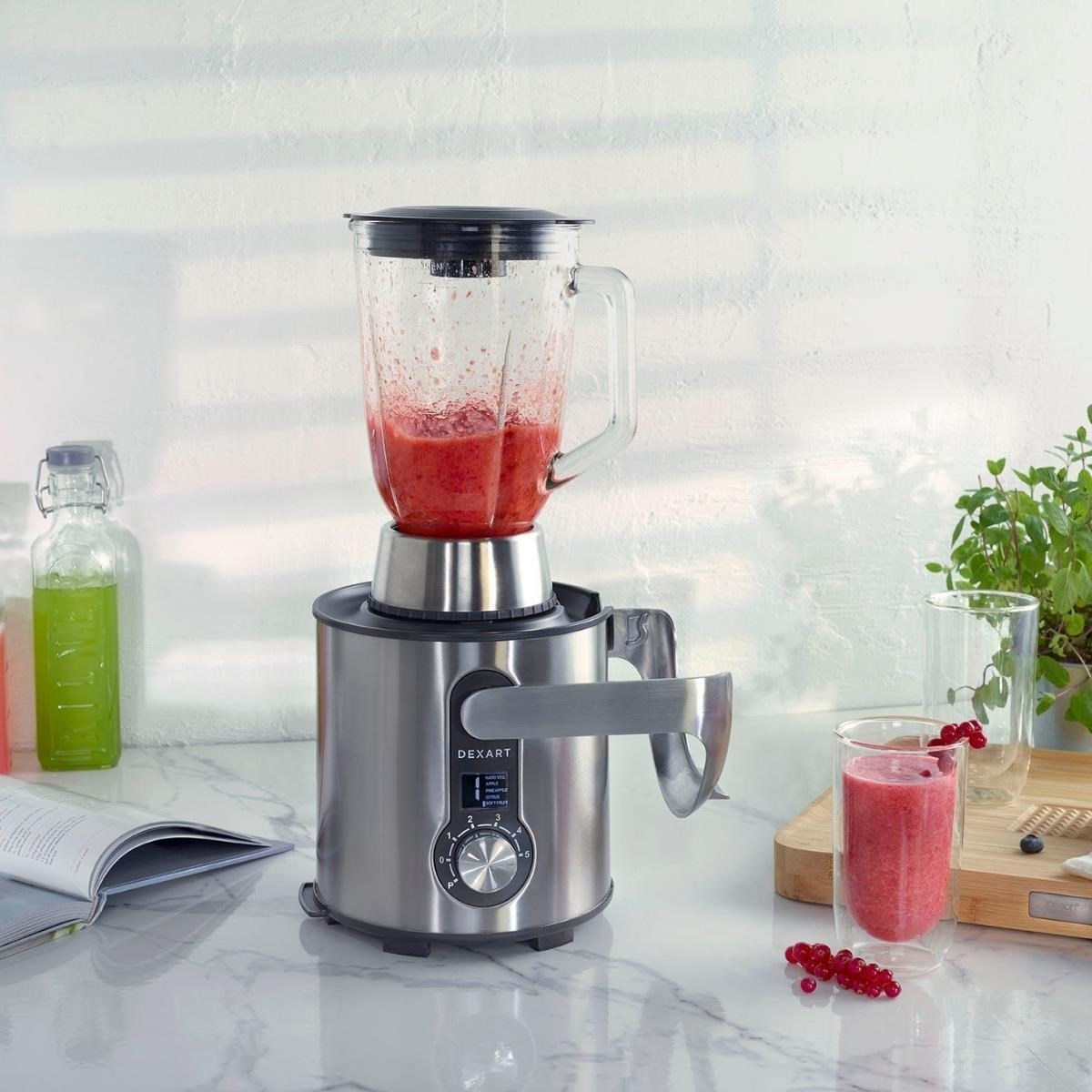 Kırmızı meyve püreli gümüş blender, yanında bir bardak smoothie.