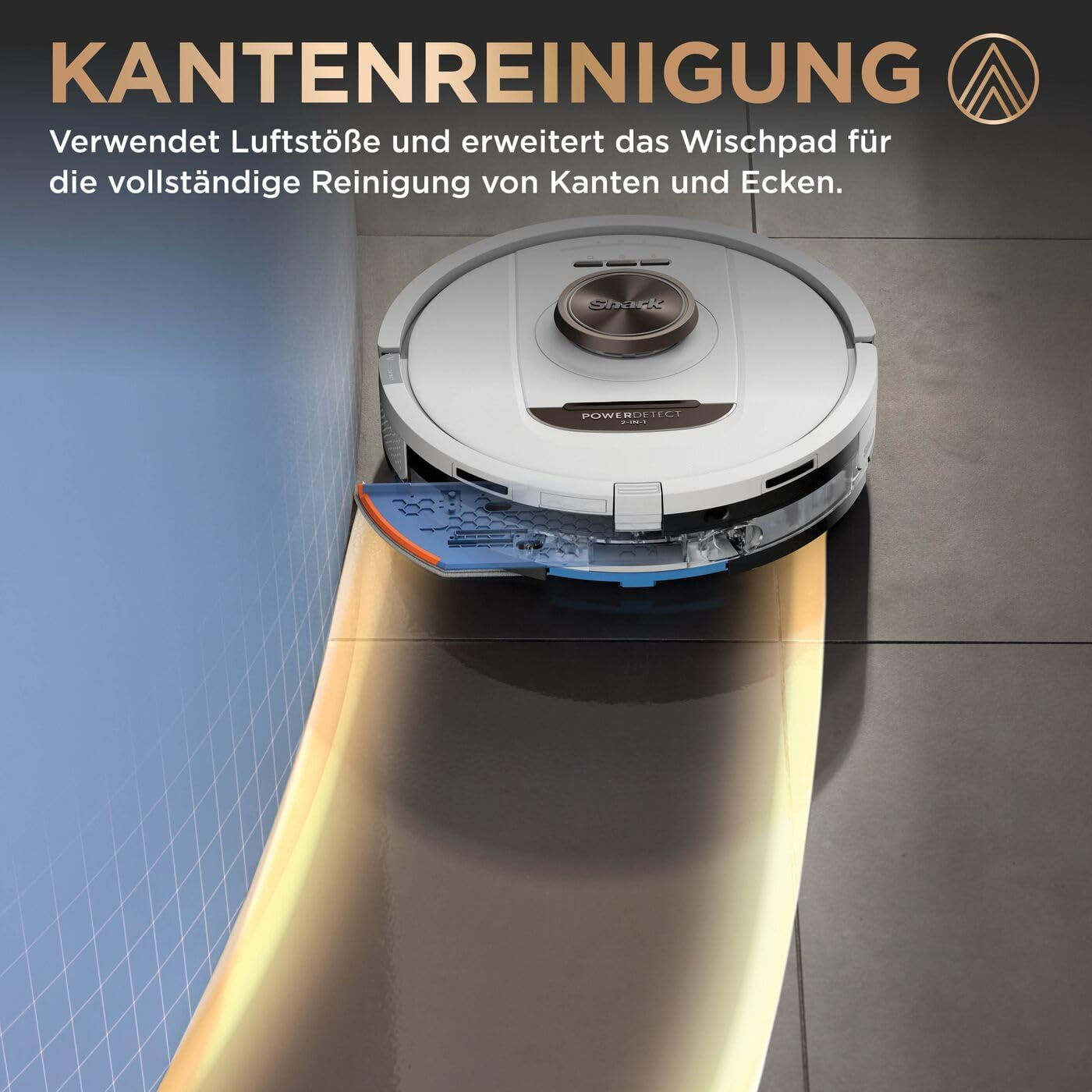 A white robot vacuum cleans a corner with an extended mop pad.