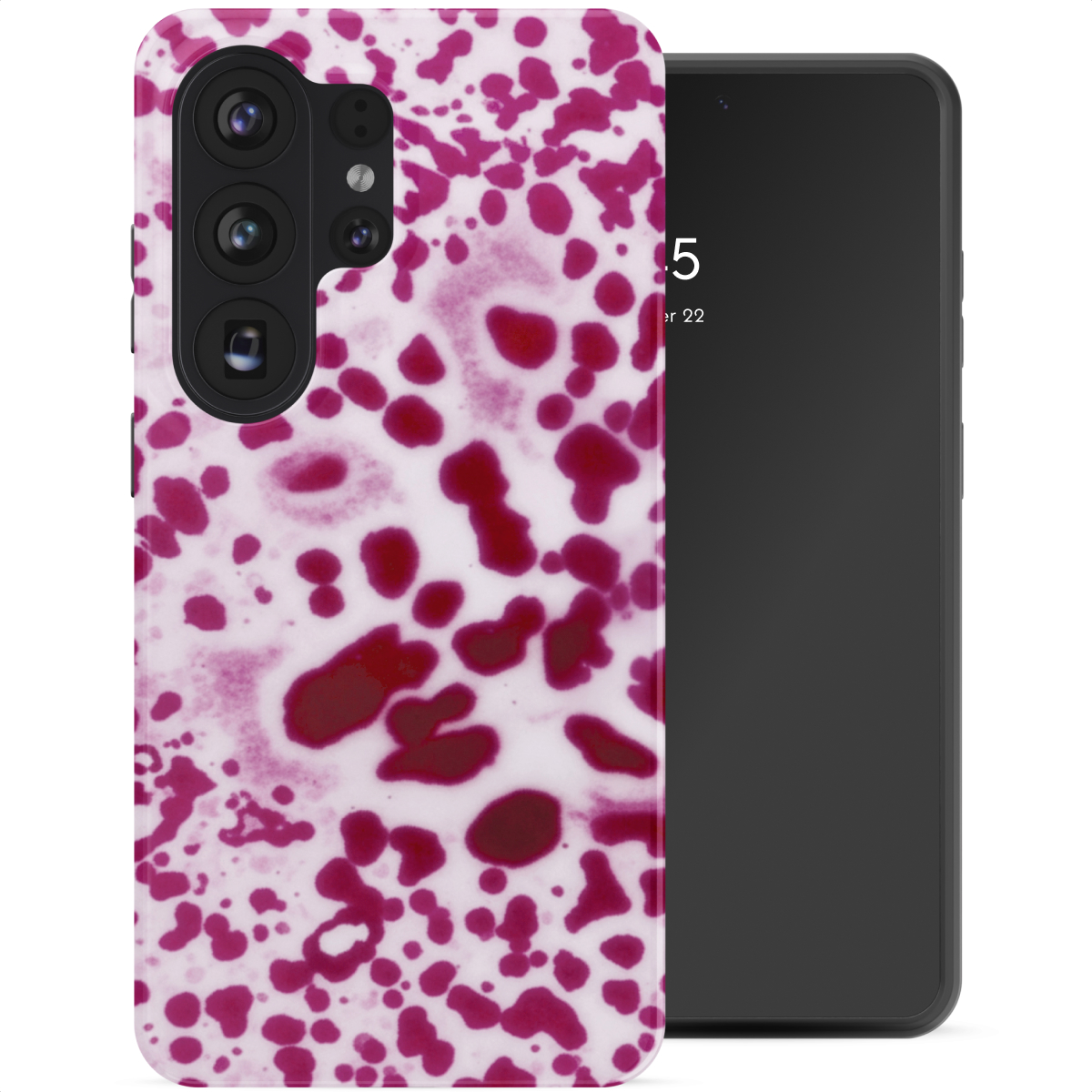 Un smartphone avec un étui orné d'un motif de taches rouges sur fond blanc.