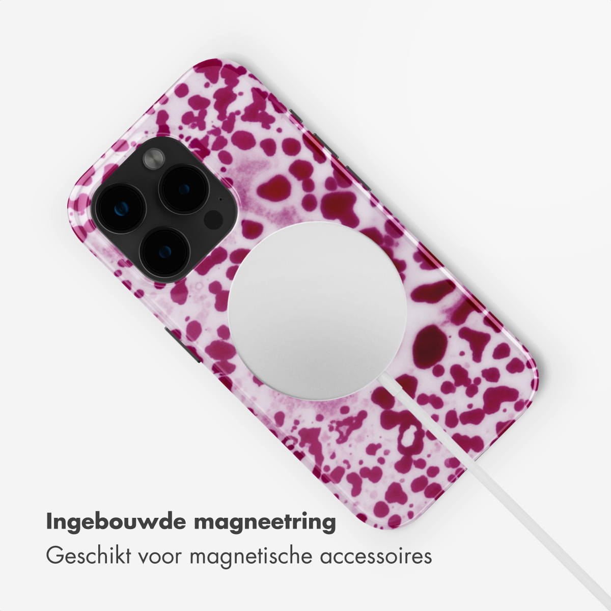 Una cover per telefono a fantasia rosa con anello magnetico bianco.