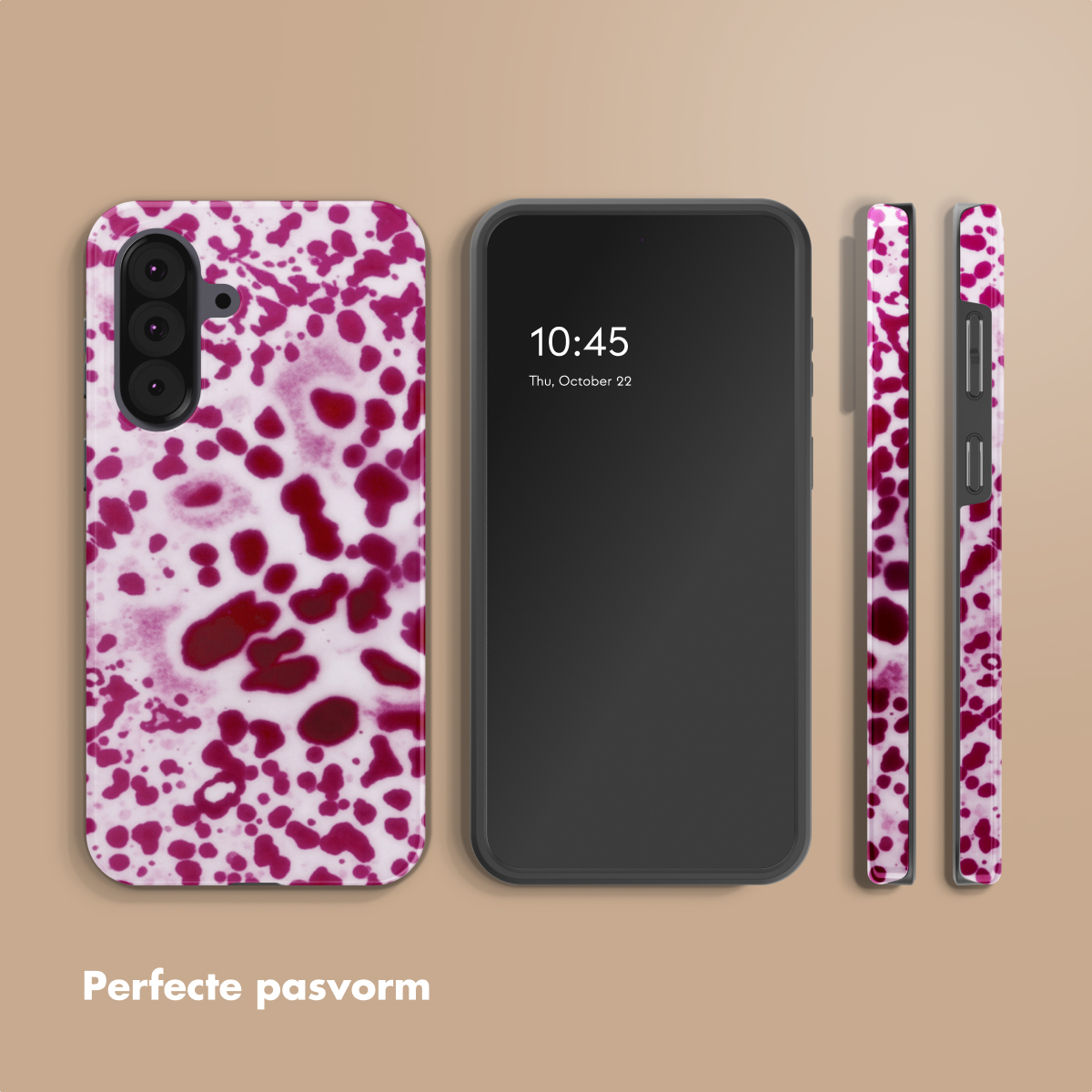 Un smartphone avec une coque de téléphone à pois rouges et blancs, à côté d'un téléphone noir.