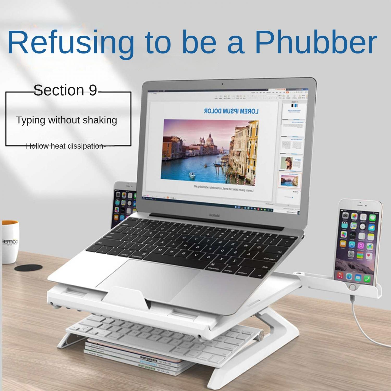 Ein Laptop auf einem Ständer mit Tastatur und Handy. "Refusing to be a Phubber"