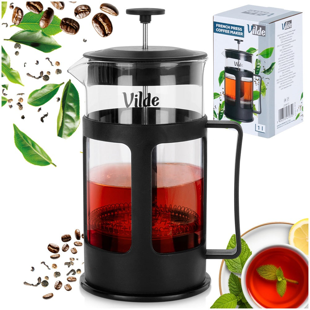 Prensa francesa Vilde con té rojo, granos de café, hojas y limón.