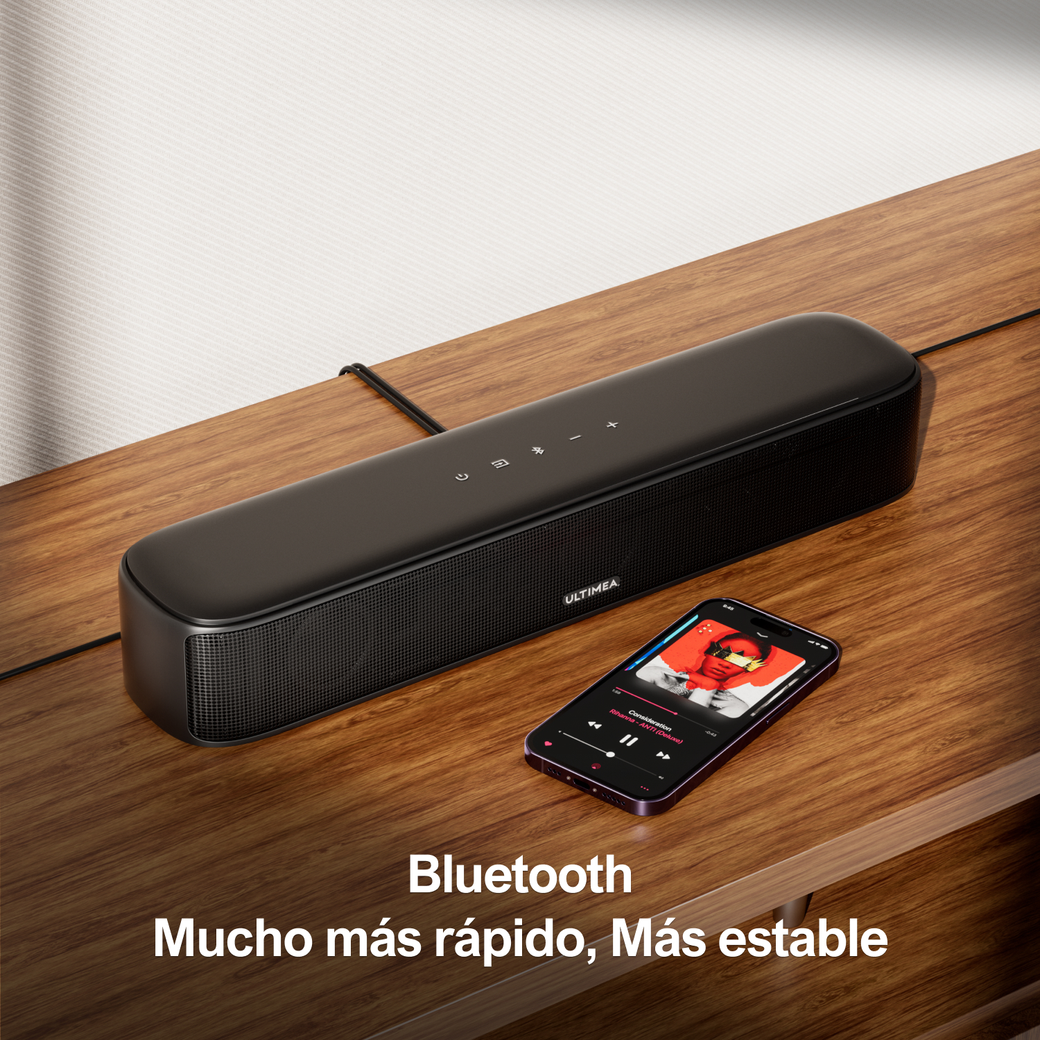 Czarny głośnik Bluetooth obok smartfona odtwarzającego muzykę.