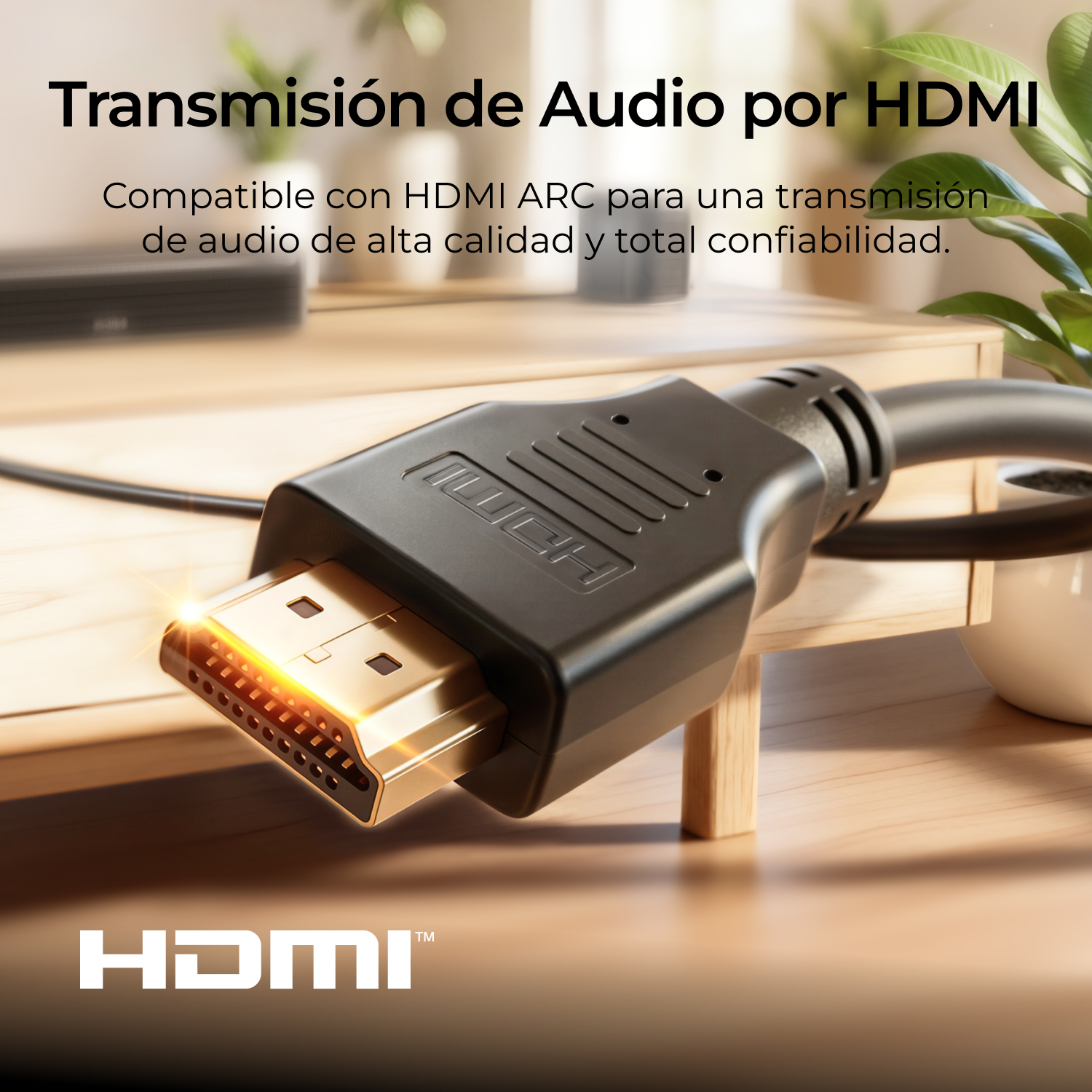 Primer plano de un cable HDMI negro con conector dorado sobre una mesa de madera.