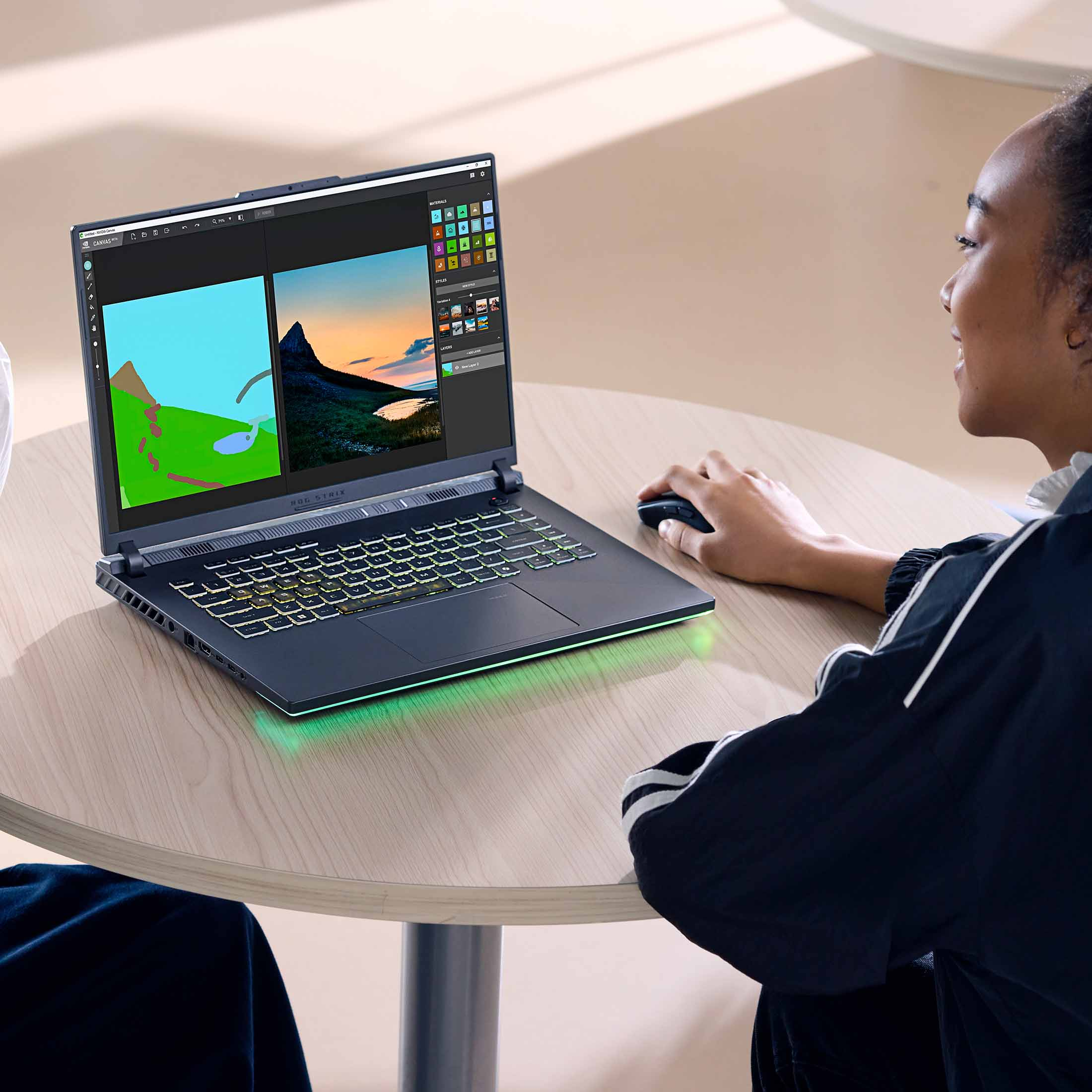 Eine Person benutzt einen Laptop mit einer Grafiksoftware. Beleuchtete Tastatur.