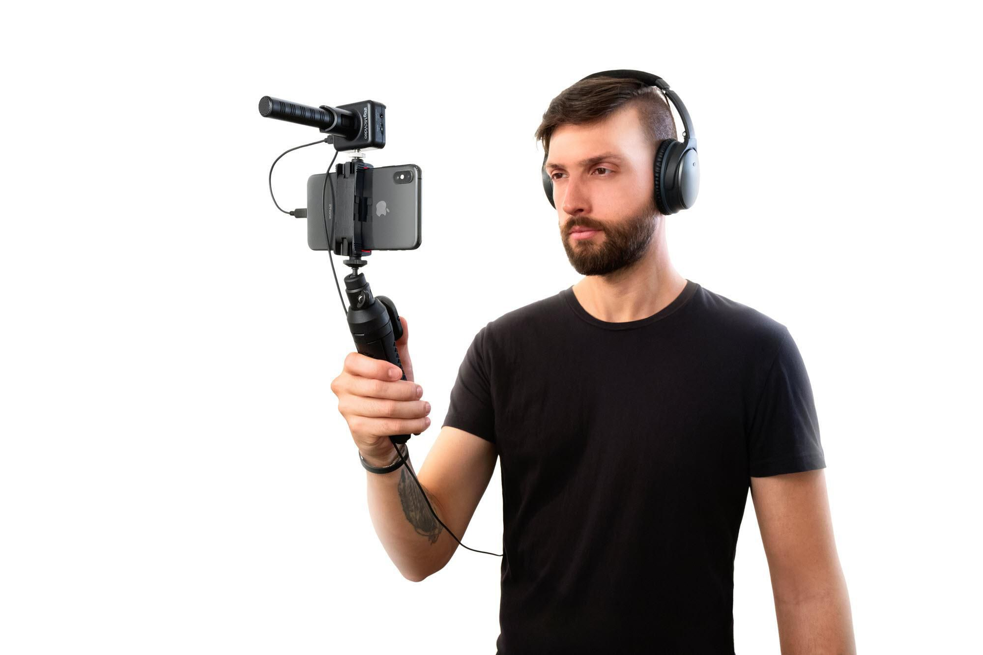 Uomo con cuffie tiene telefono con microfono e impugnatura.