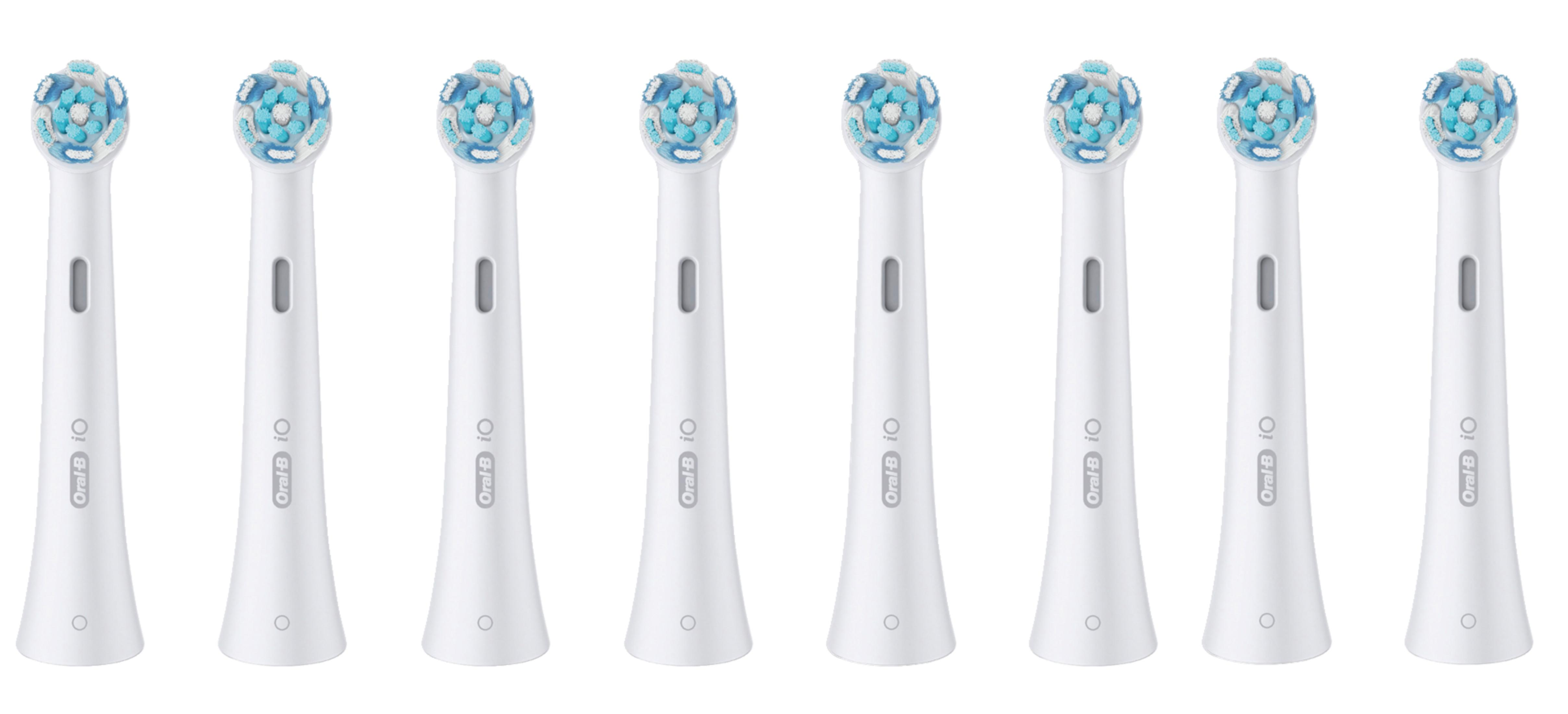 A row of eight white Oral-B iO toothbrush heads with blue and white bristles.