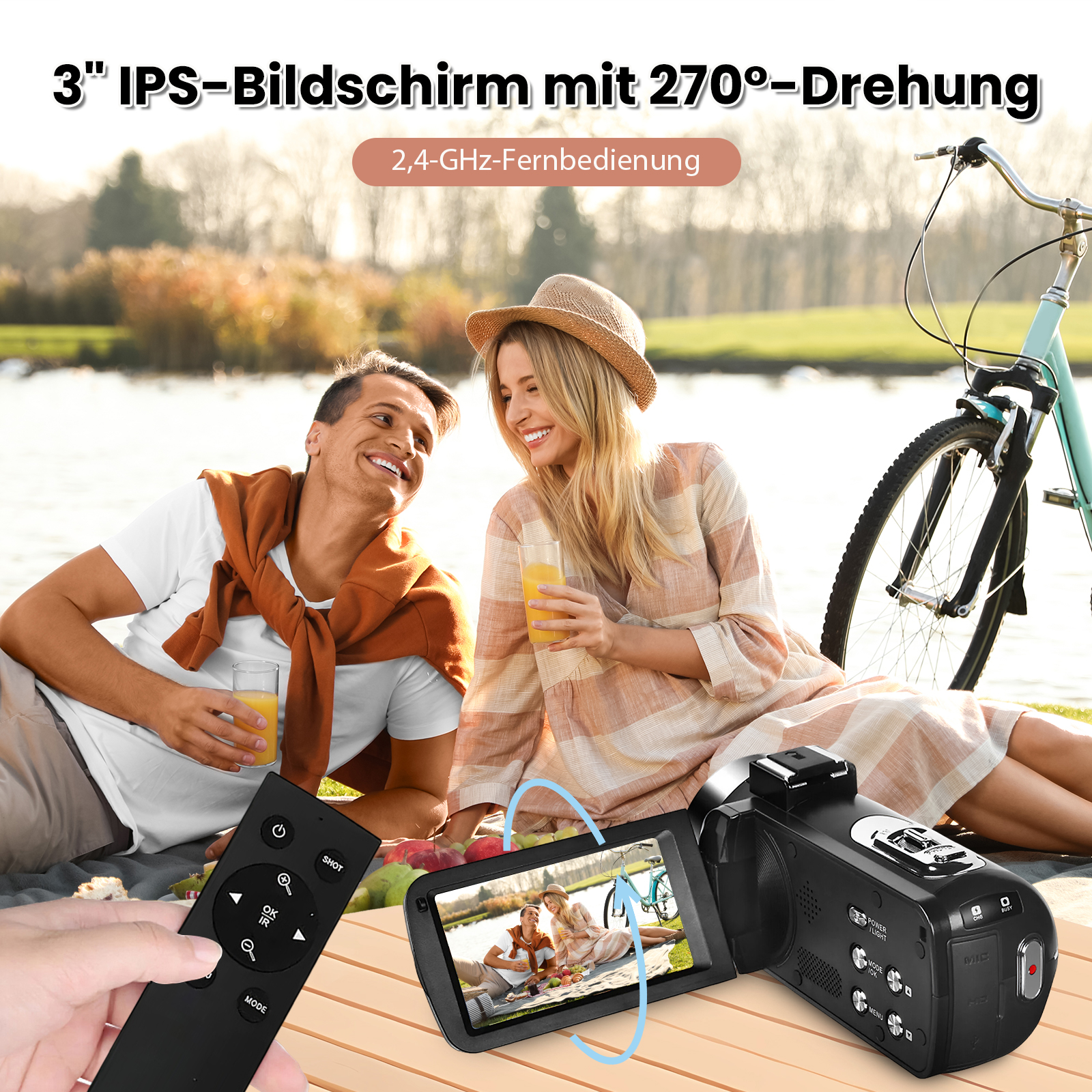Ein Paar genießt ein Picknick am See. Ein Camcorder und eine Fernbedienung liegen im Vordergrund.