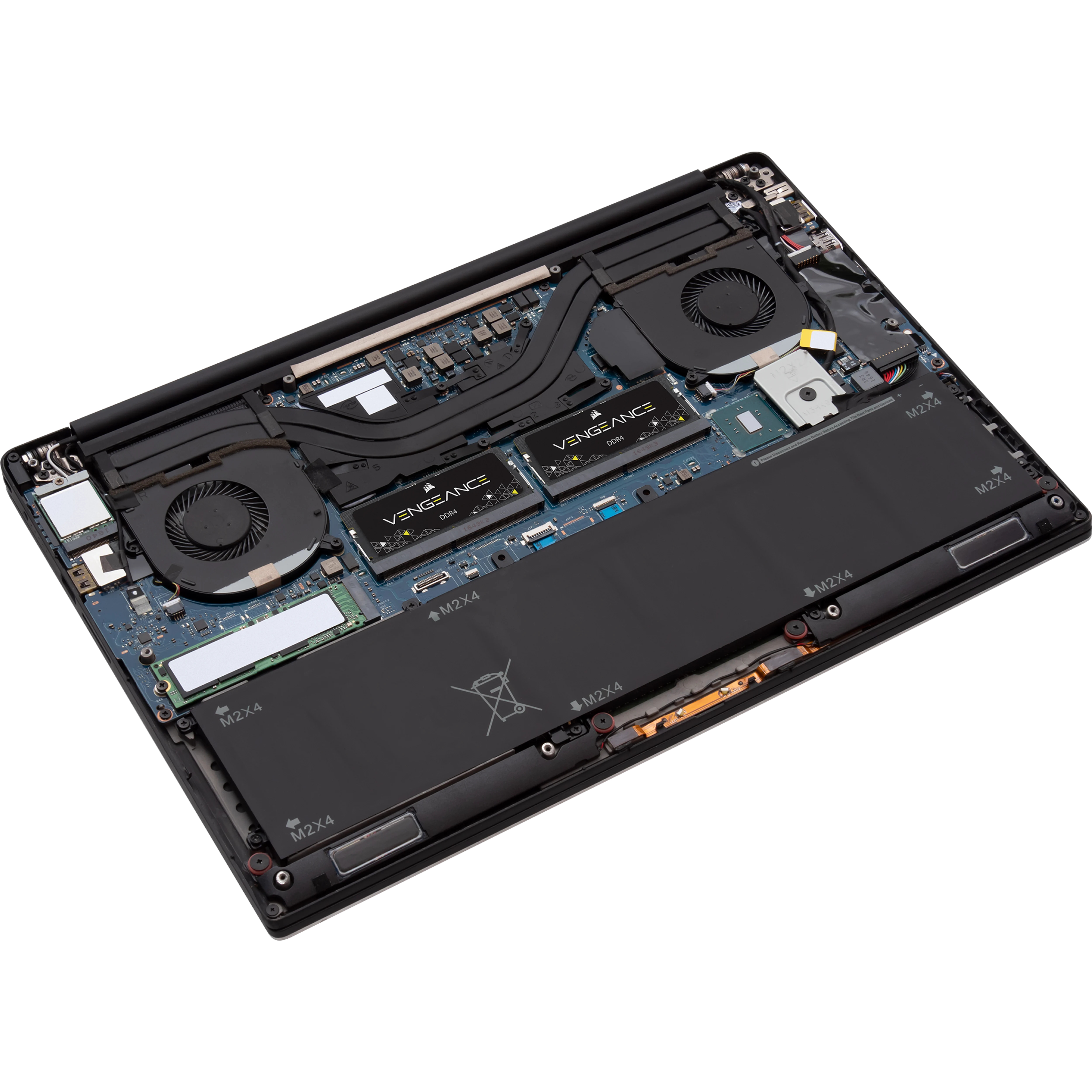 Otwarty laptop z widocznymi komponentami wewnętrznymi: bateria, wentylatory, moduły RAM i płyta główna.