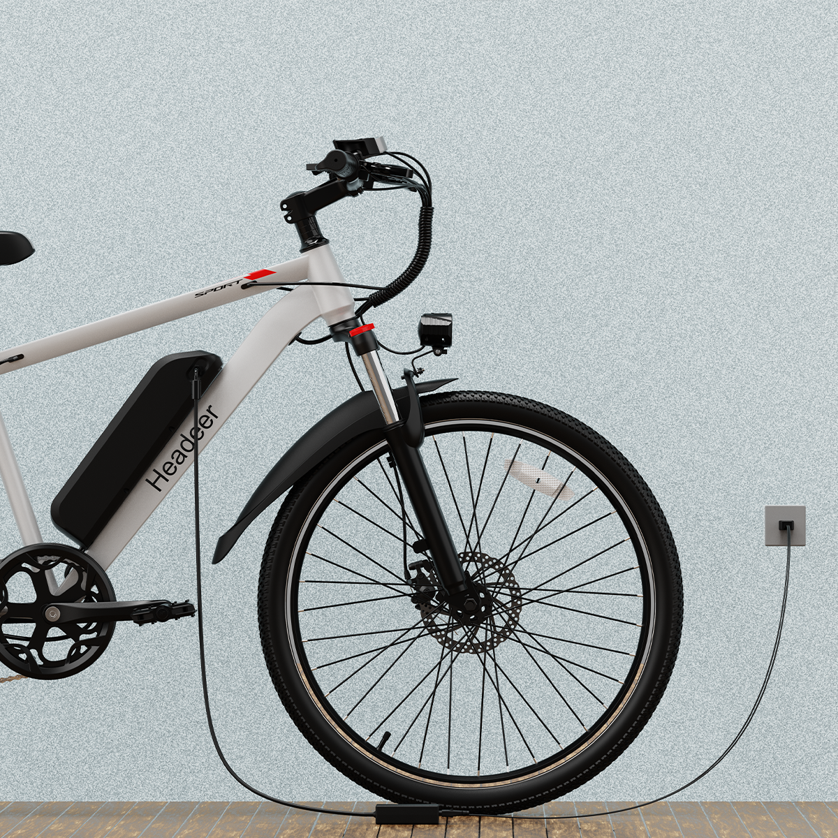 Biały rower elektryczny z czarną baterią ładuje się przy ścianie.