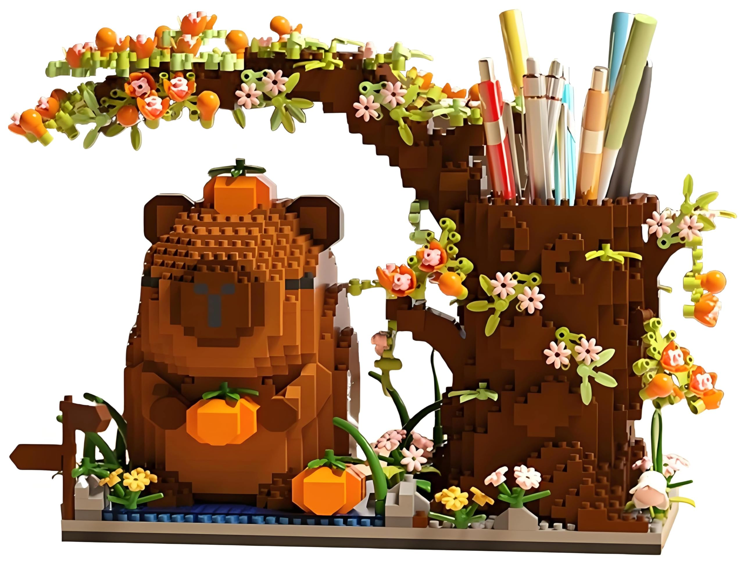 Ein Ziegelbär hält eine Orange. Ein baumartiger Stiftehalter mit Stiften und Blumen.