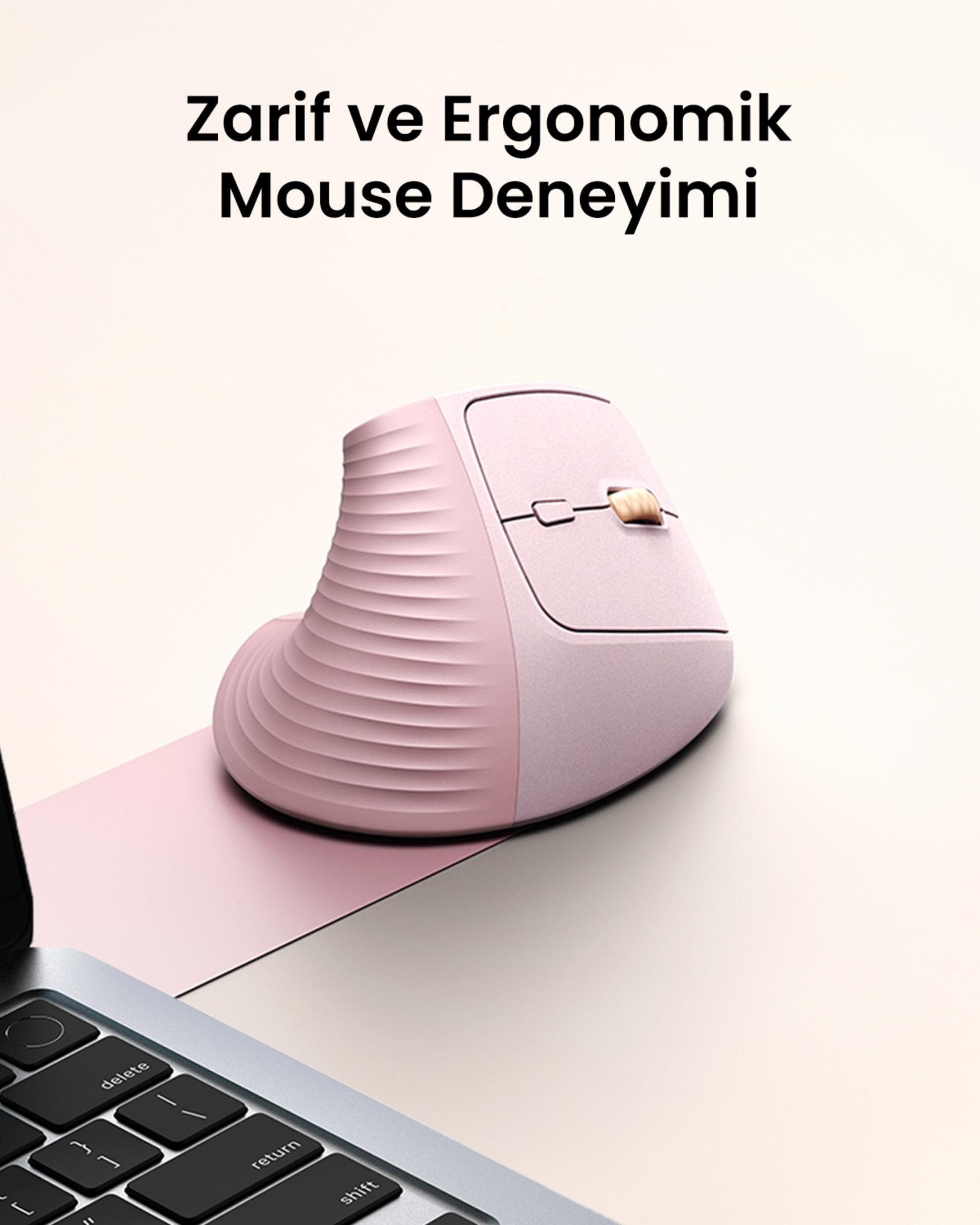 Różowa pionowa mysz i klawiatura laptopa na stole.
