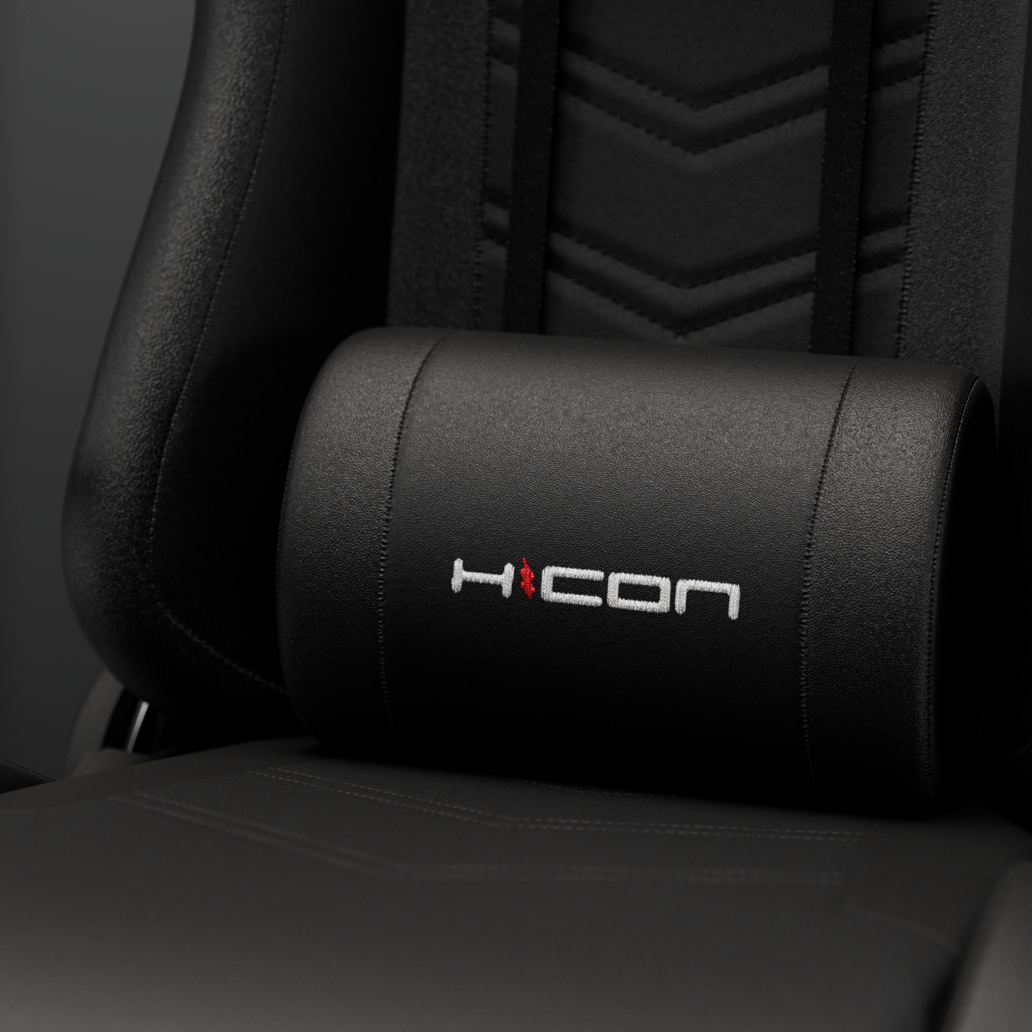 Black chair with a headrest pillow featuring a logo with a red flame and white text.