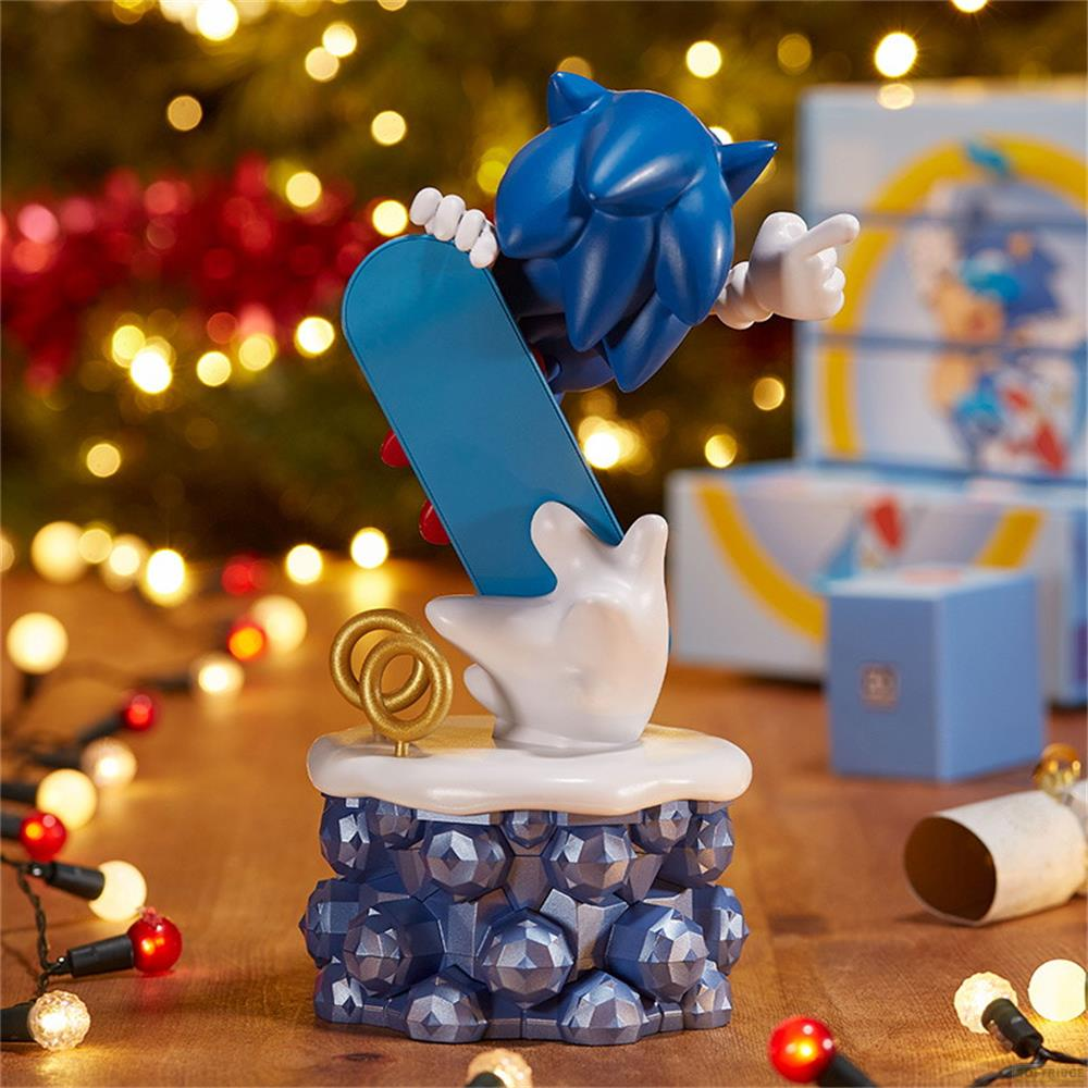 Sonic auf einem Skateboard auf einem blauen, facettierten Sockel, Weihnachtslichter im Hintergrund.