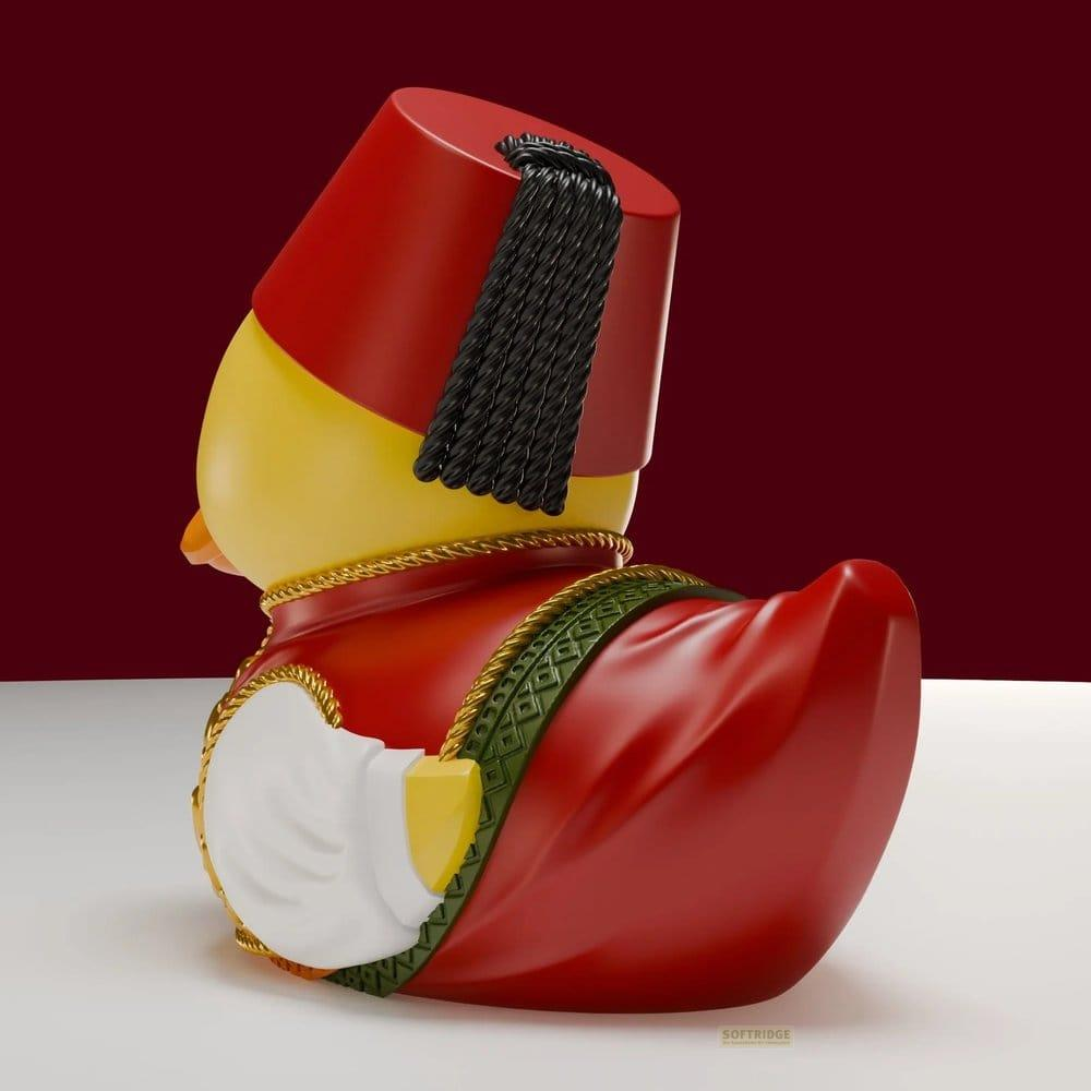 Ein gelber Gummi-Ente mit einem roten Fes und einem roten Gewand.