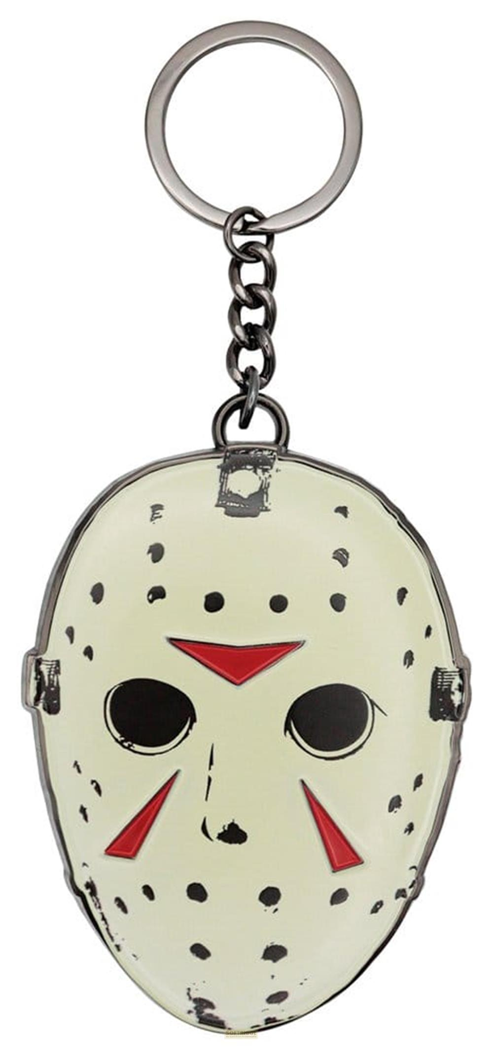 Ein Schlüsselanhänger in Form einer cremefarbenen Hockeymaske mit schwarzen Löchern und roten Dreiecken.