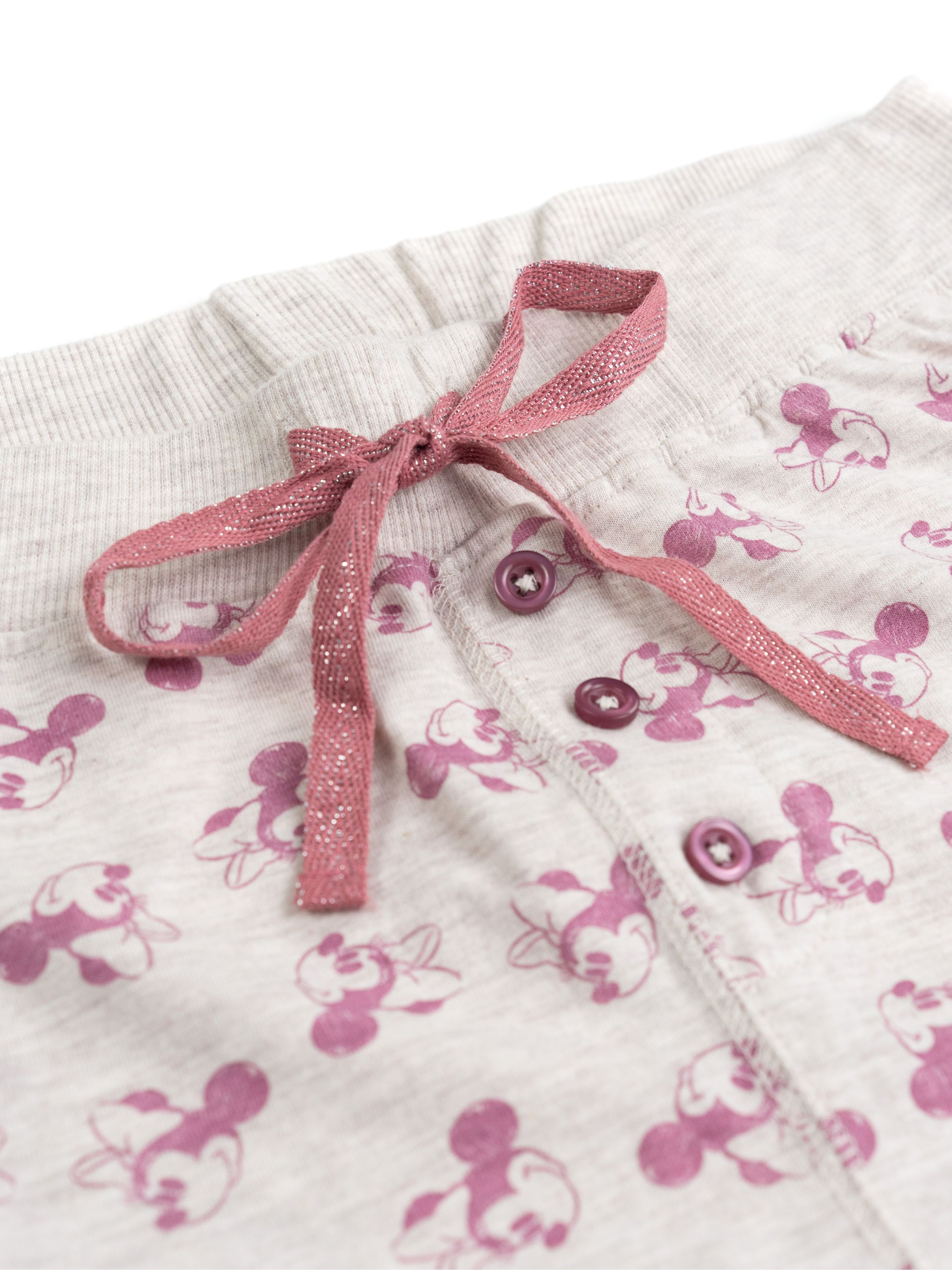 Graue Hose mit Micky-Maus-Muster und rosa Schleife.