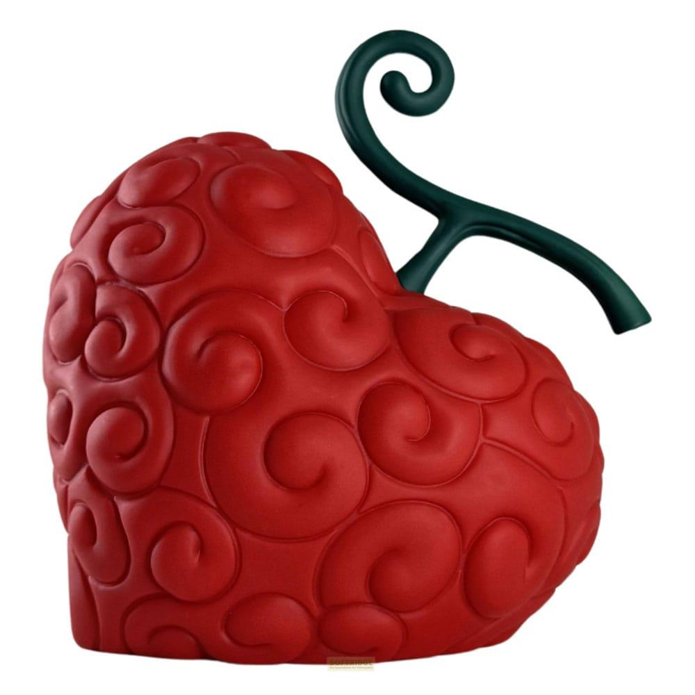Eine rote, herzförmige Teufelsfrucht mit grünen Ranken und spiralförmigen Mustern.