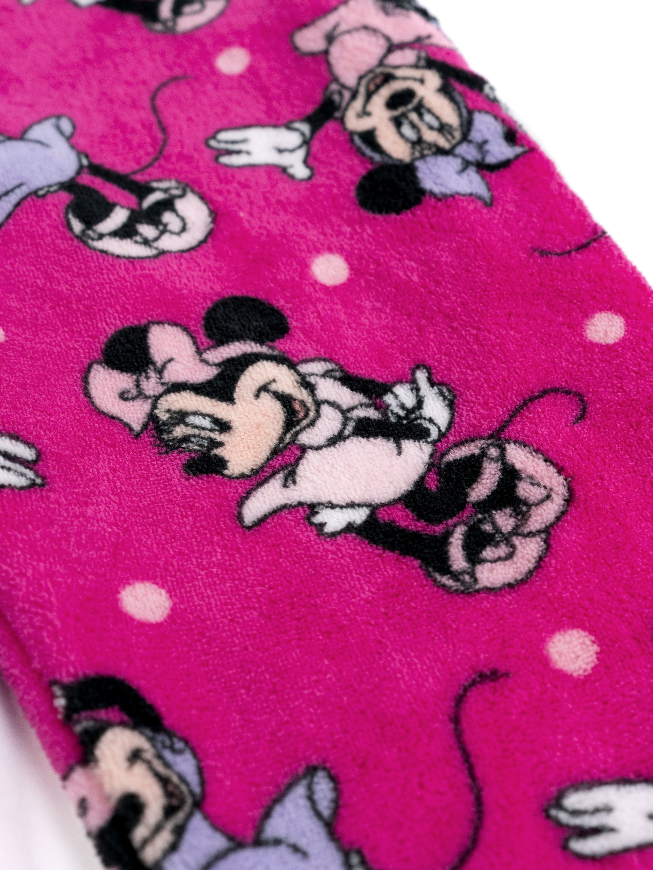 Stoff mit pinkem Hintergrund und Micky Maus-Motiven. Kleine weiße Punkte sind sichtbar.