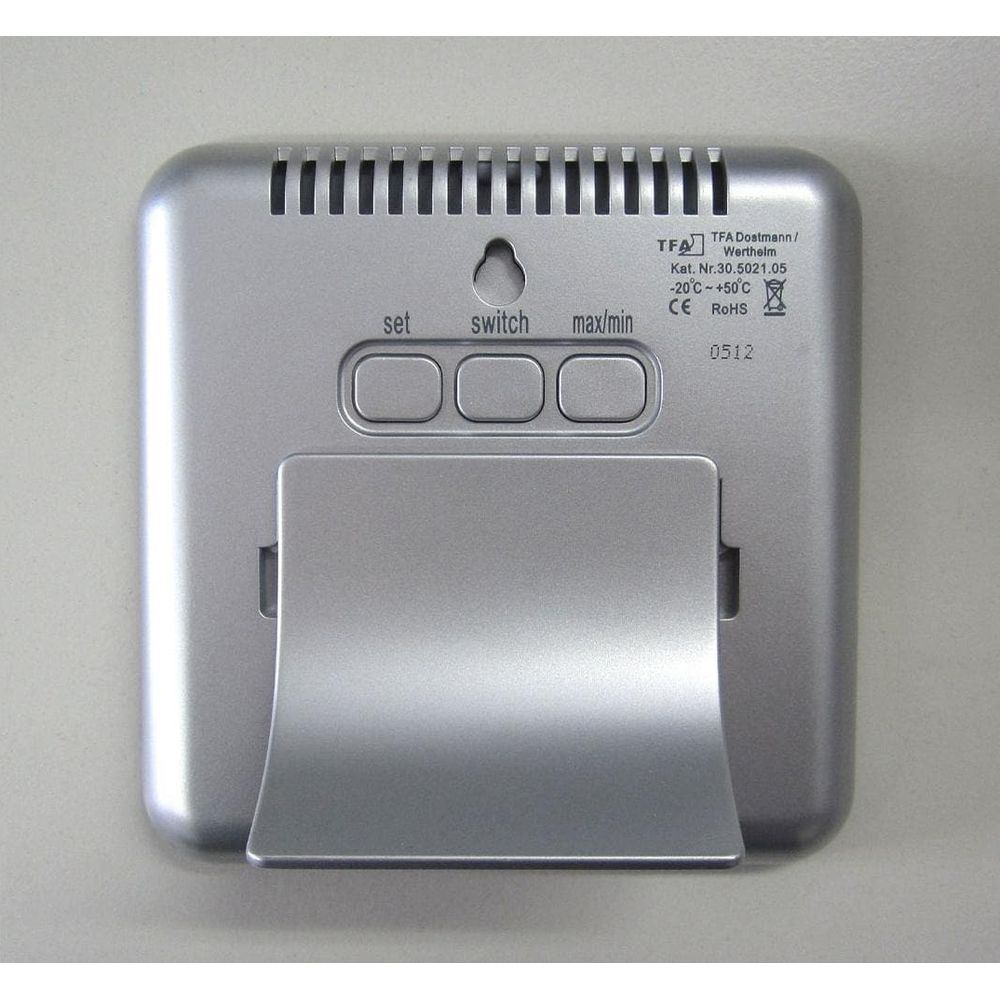 Retro di un termometro digitale con pulsanti e supporto.
