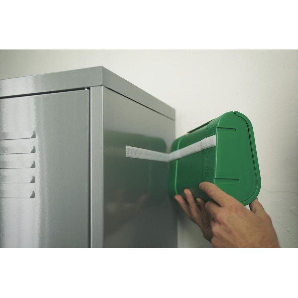 A green box with a white strip is attached to a gray locker.