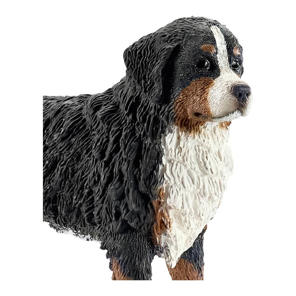 Figurka psa rasy berneński pies pasterski z czarną, białą i brązową sierścią.