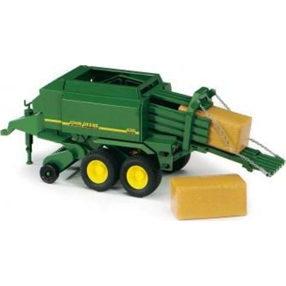 Zielona prasa do bel John Deere zabawka z żółtymi belami.